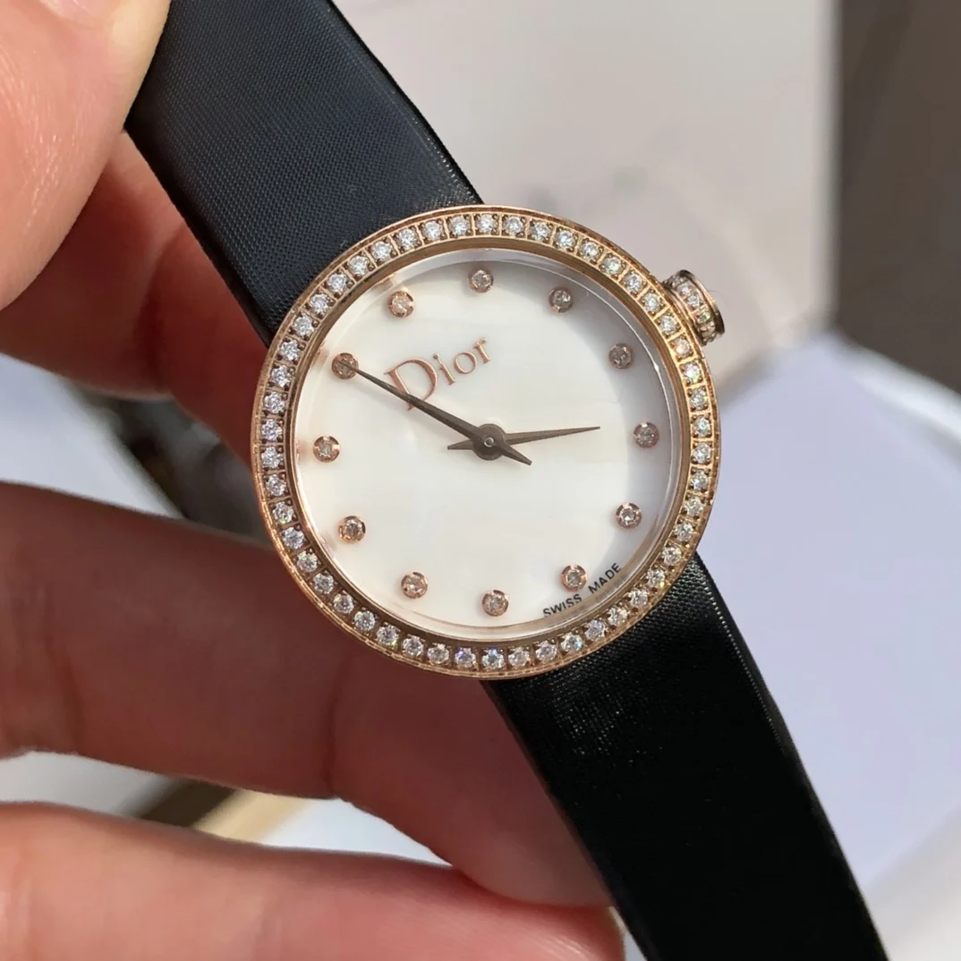 2 White mother-of-pearl dial set with 12 diamond hour markers — photographed off the sweep
