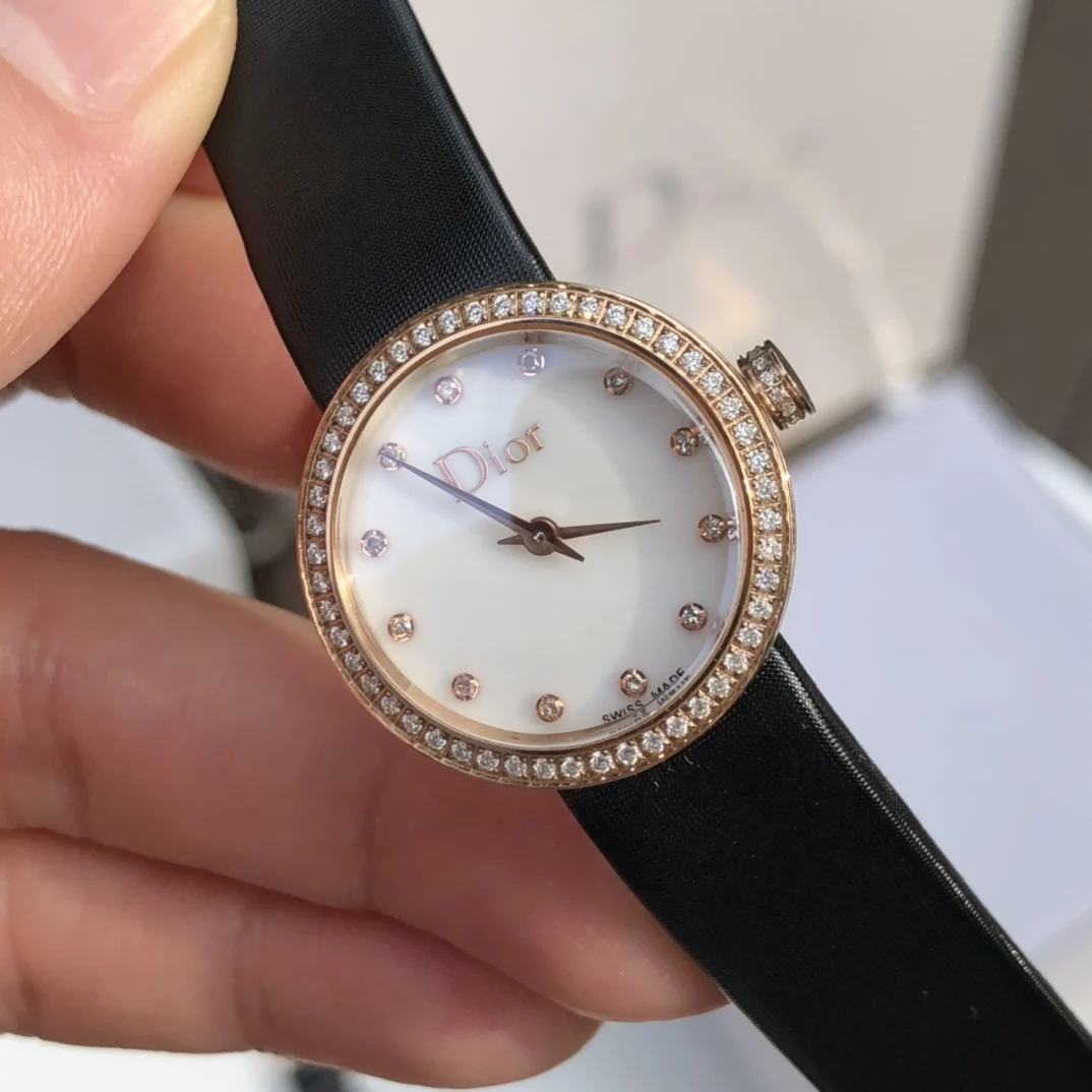 2 White mother-of-pearl dial set with 12 diamond hour markers — photographed off the sweep