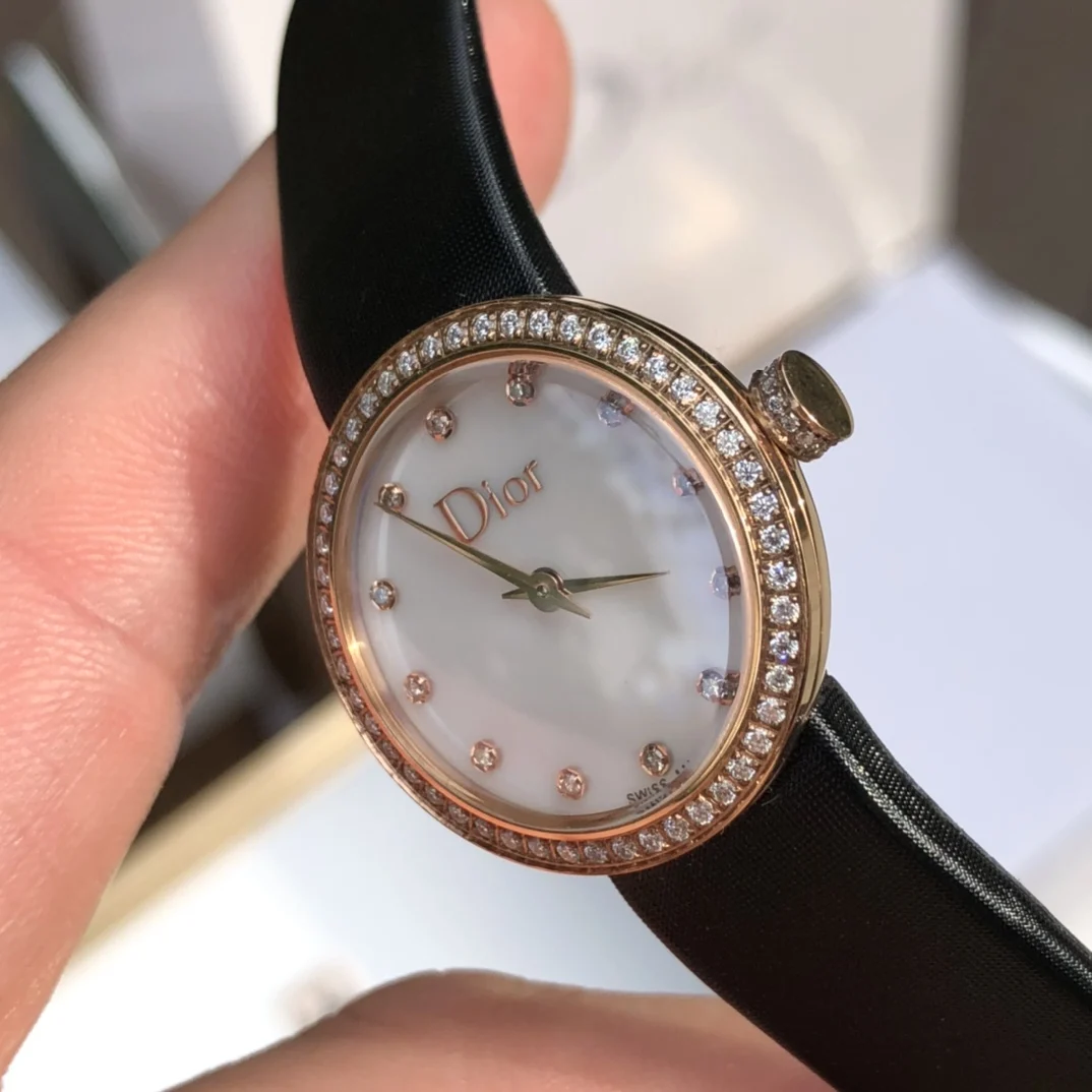 2 White mother-of-pearl dial set with 12 diamond hour markers — photographed off the sweep