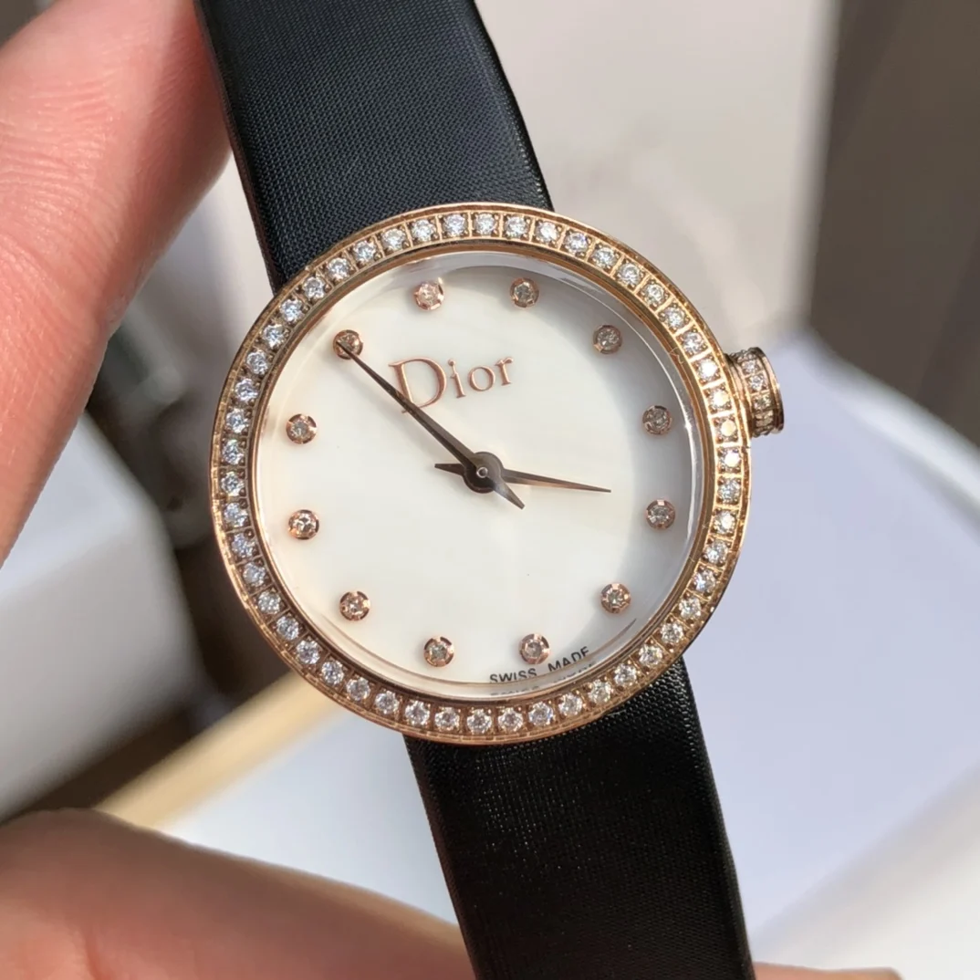 2 White mother-of-pearl dial set with 12 diamond hour markers — photographed off the sweep