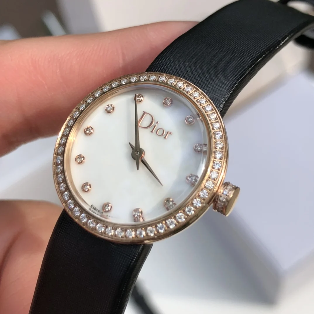 2 White mother-of-pearl dial set with 12 diamond hour markers — photographed off the sweep