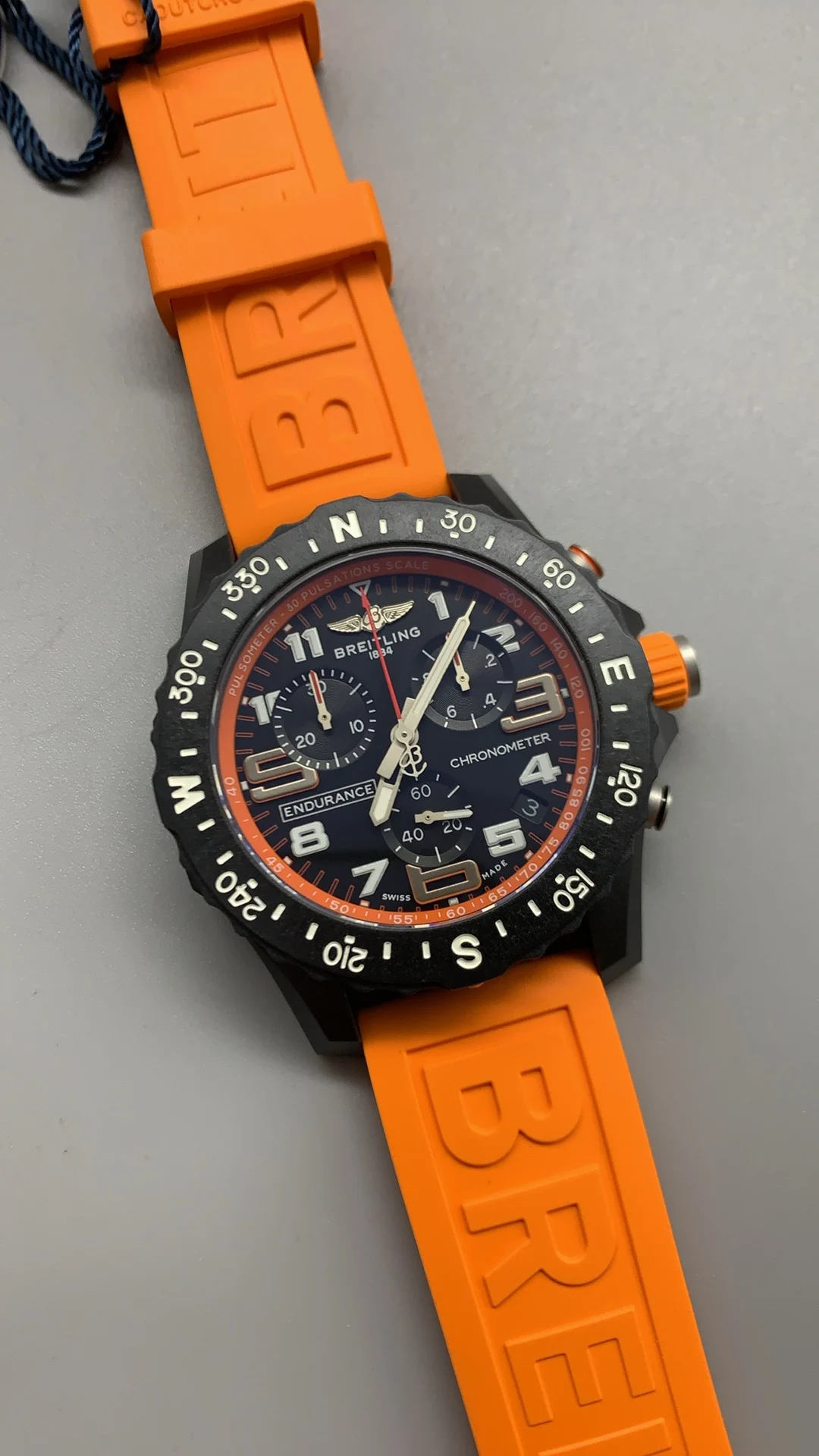 Breitling Carbon Orange Dial — photographed off the sweep