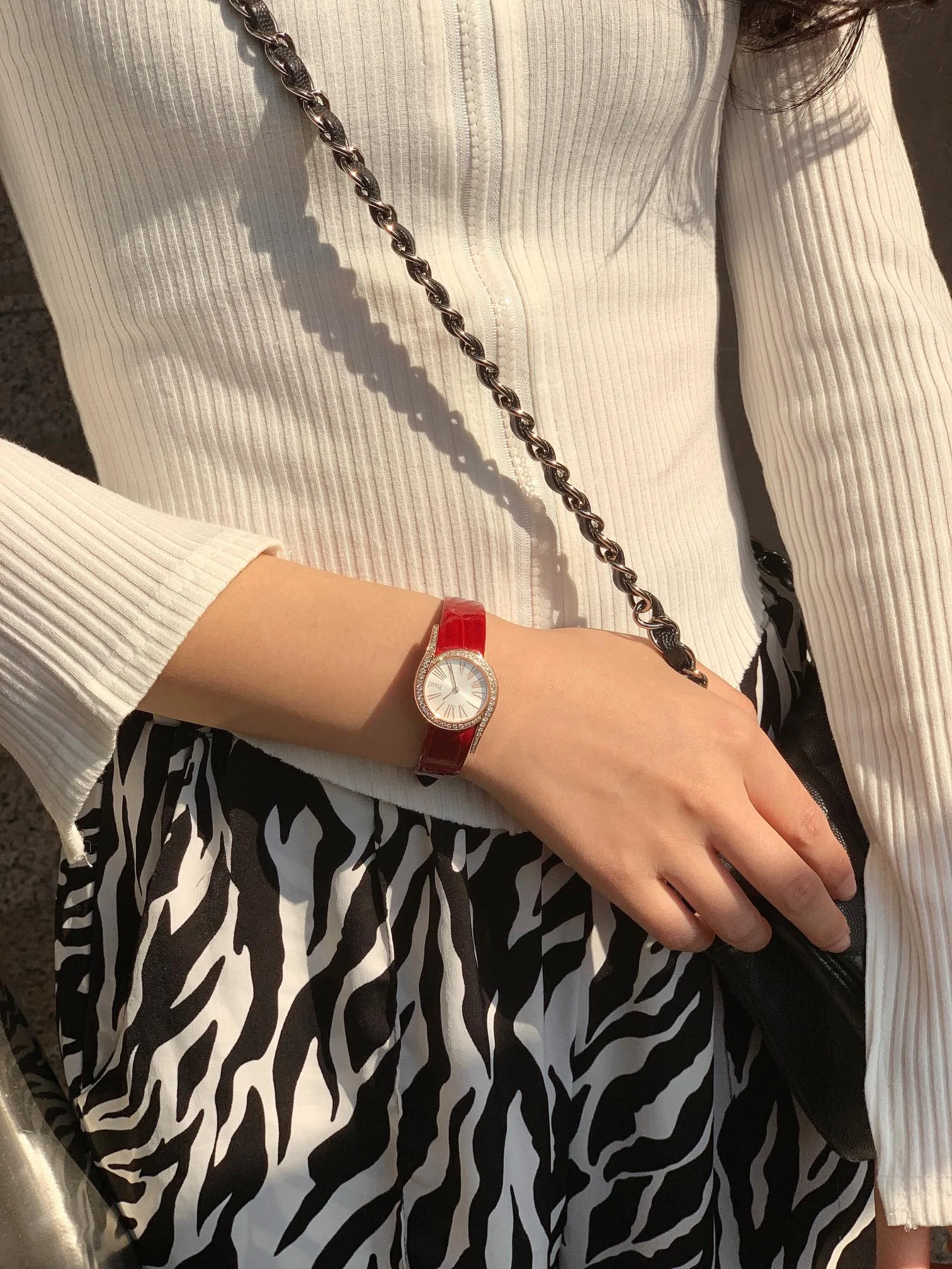 Chic red alligator leather strap — photographed off the sweep