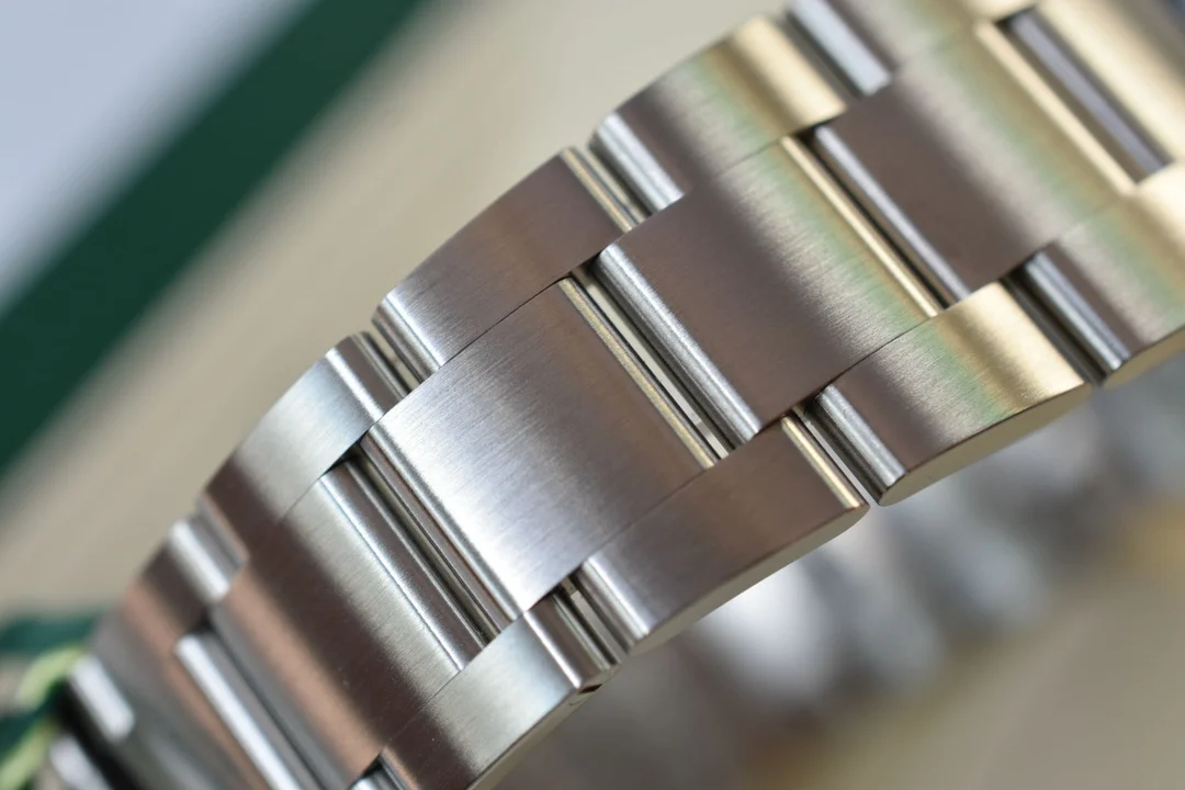 Exclusive 904 stainless steel bracelet; most watches on — photographed off the sweep