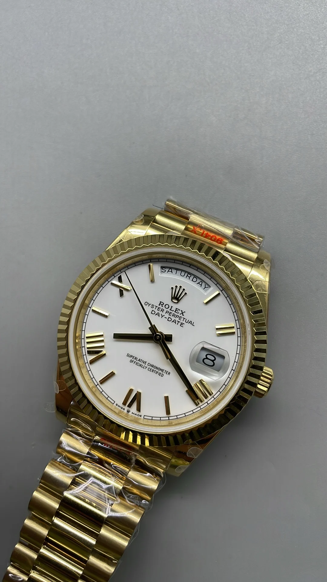 GMF, 40mm, gold ceramic, white Roman numerals, weighted version — photographed off the sweep
