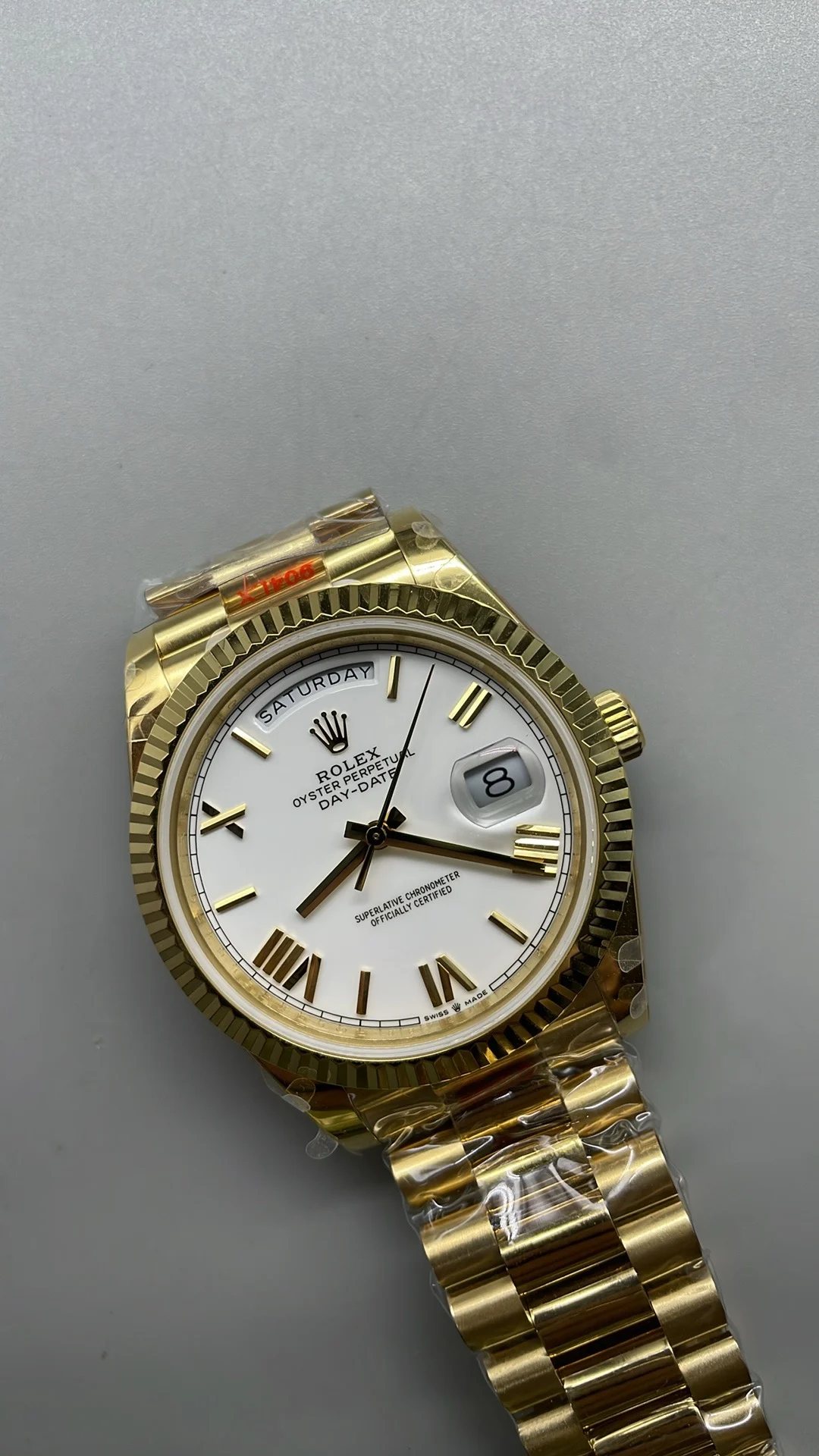 GMF, 40mm, gold ceramic, white Roman numerals, weighted version — photographed off the sweep