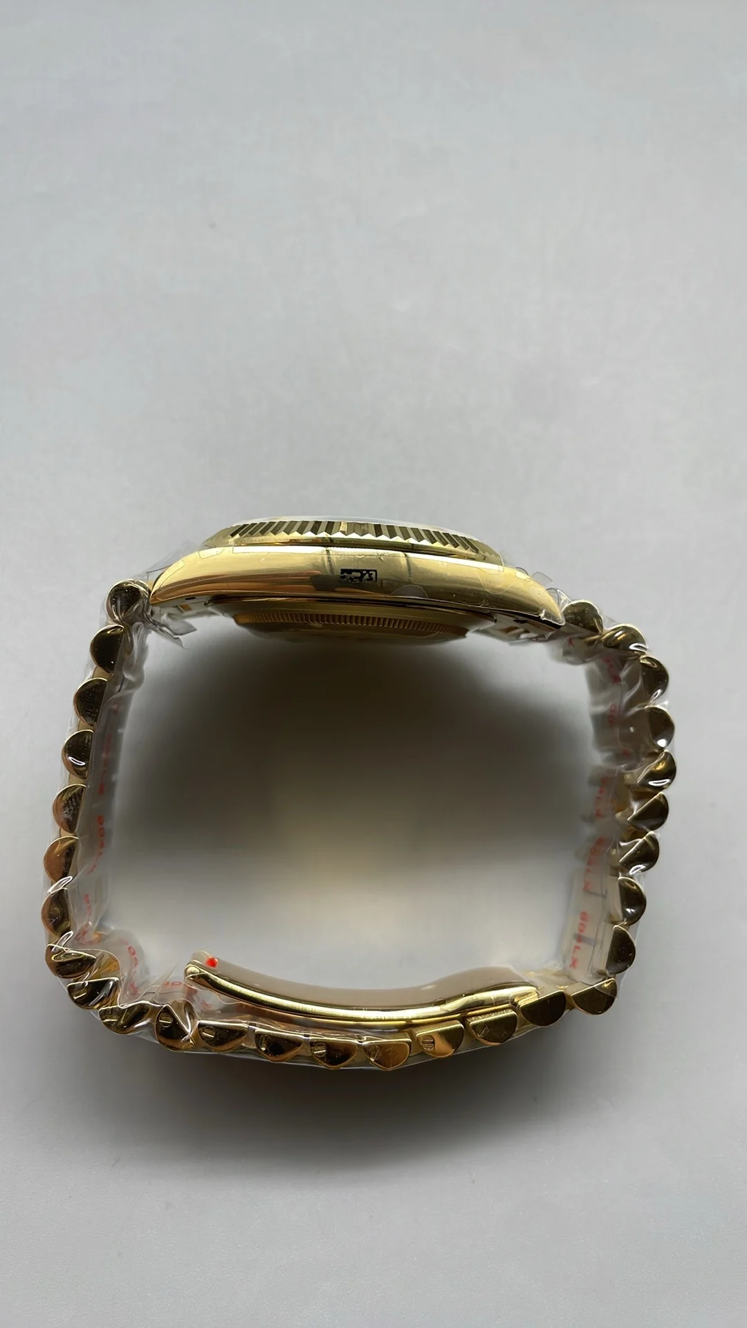GMF, 40mm, gold ceramic, white Roman numerals, weighted version — photographed off the sweep