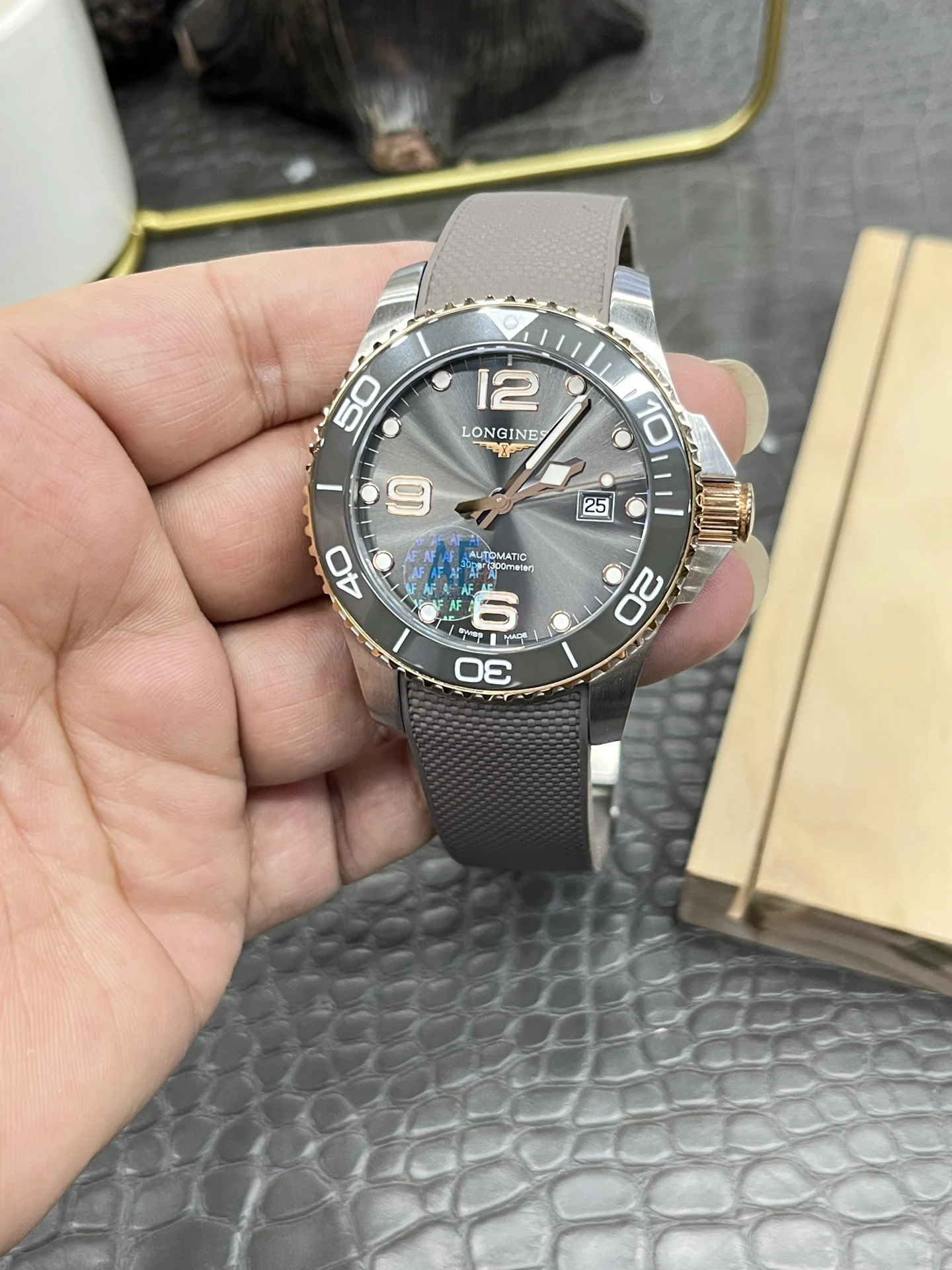 Longines Conquest Rose Gold Grey Dial — photographed off the sweep