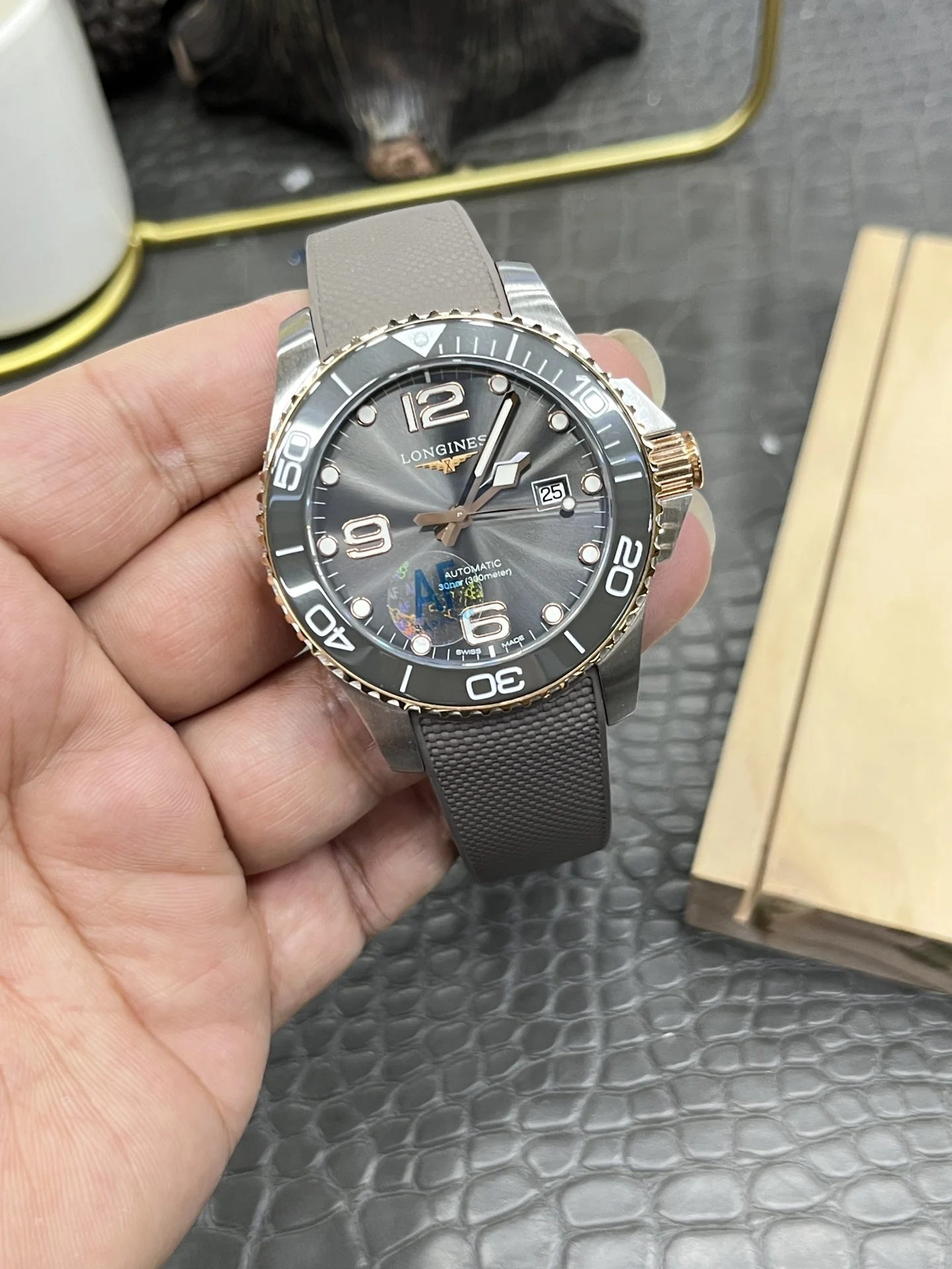 Longines Conquest Rose Gold Grey Dial — photographed off the sweep