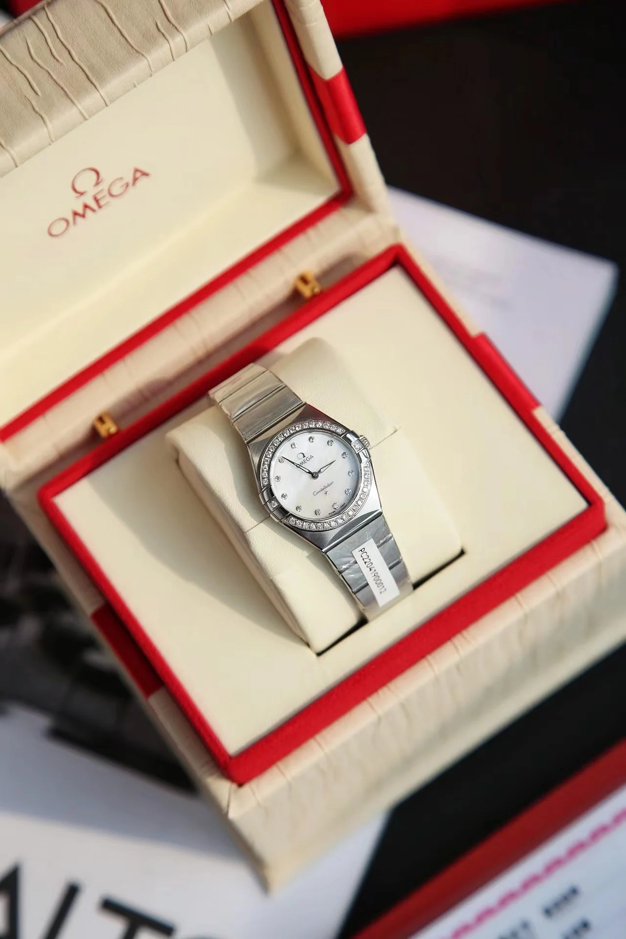 Omega Constellation Red Dial Diamond-Set 28mm — photographed off the sweep