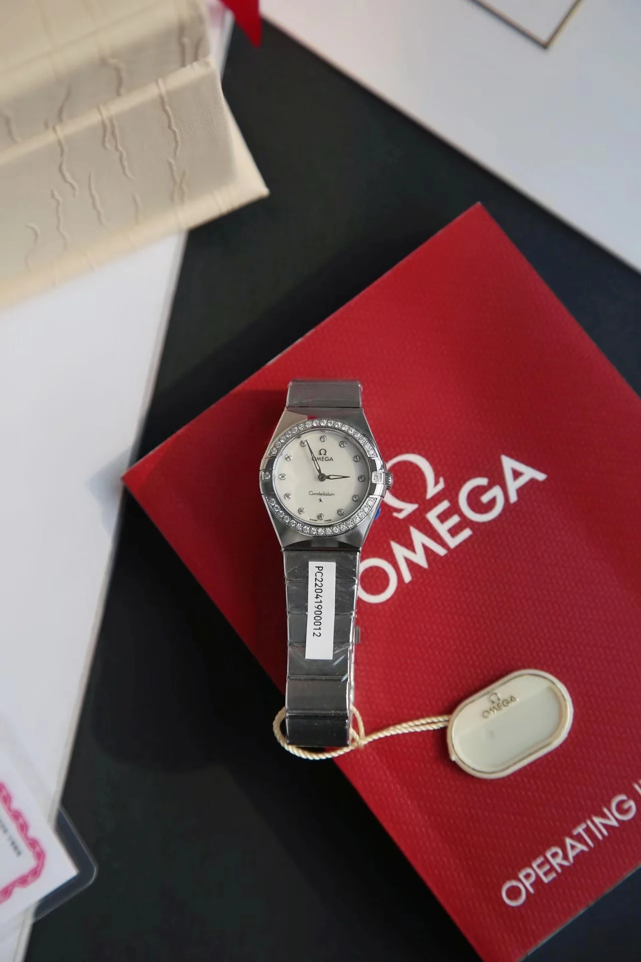 Omega Constellation Red Dial Diamond-Set 28mm — photographed off the sweep