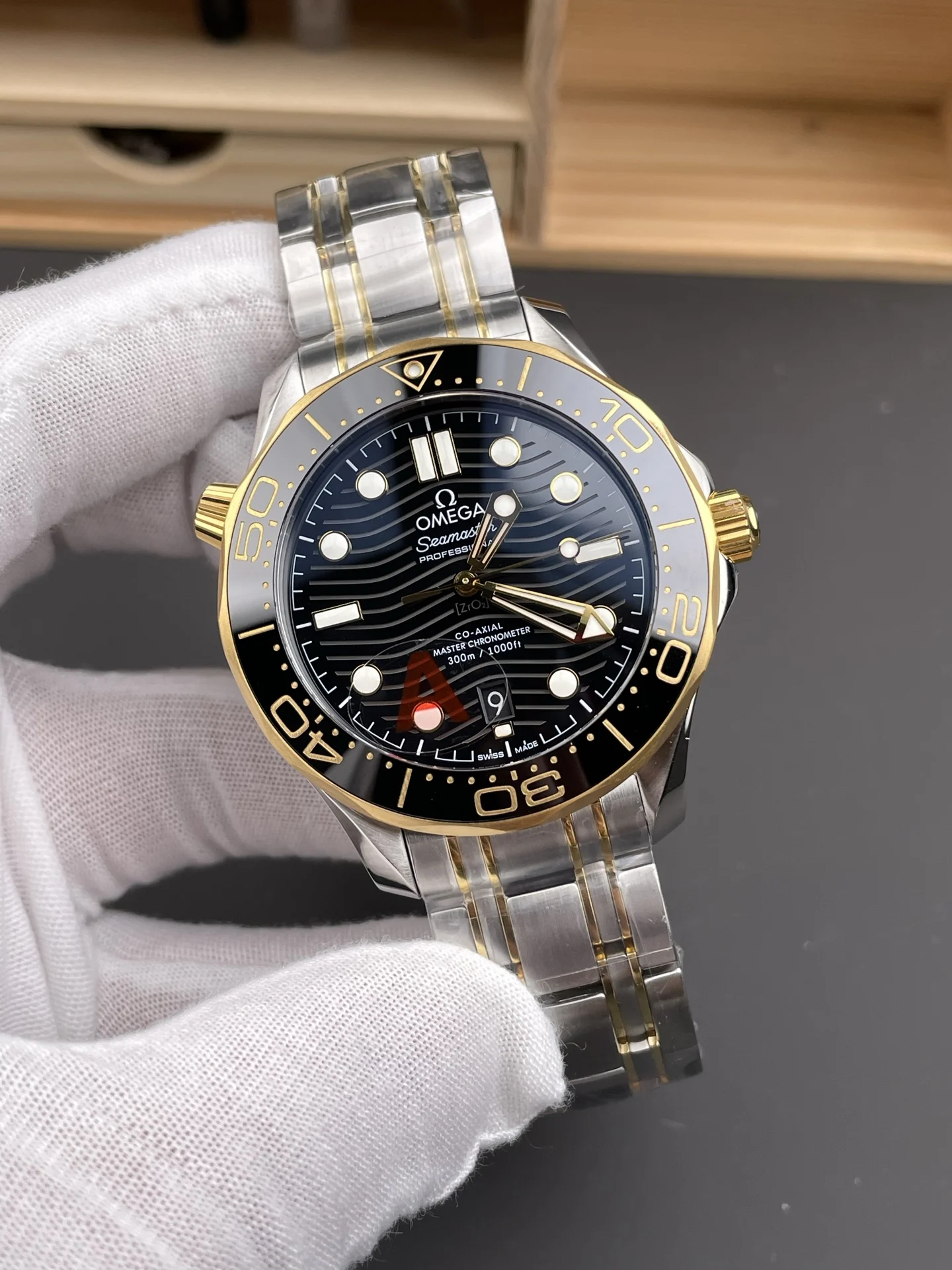 Omega Seamaster 300 Two-Tone Black Dial 42mm — photographed off the sweep