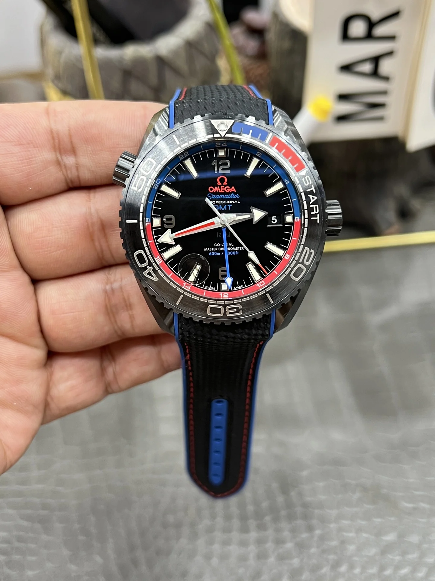 Omega Seamaster Planet Ocean Ceramic Red Dial — photographed off the sweep