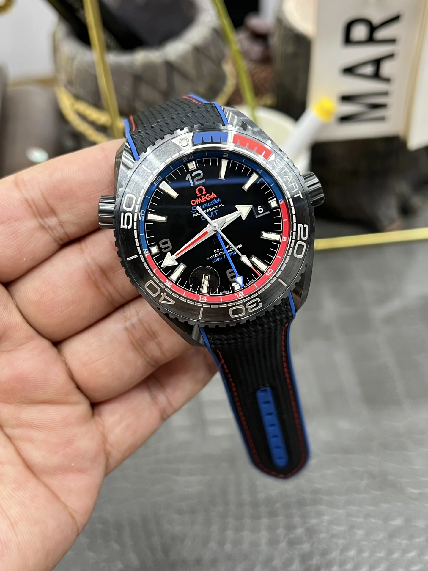 Omega Seamaster Planet Ocean Ceramic Red Dial — photographed off the sweep