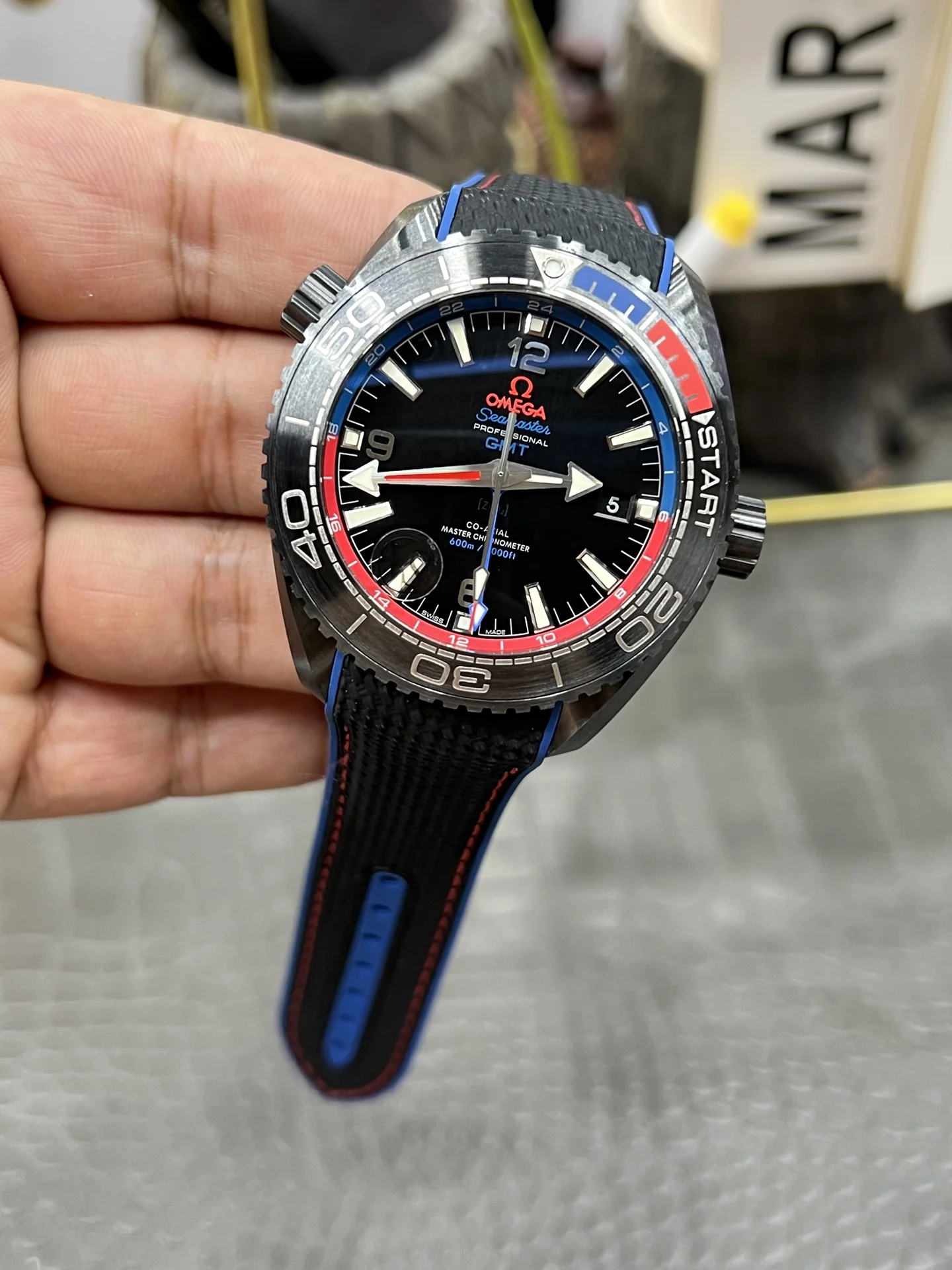 Omega Seamaster Planet Ocean Ceramic Red Dial — photographed off the sweep