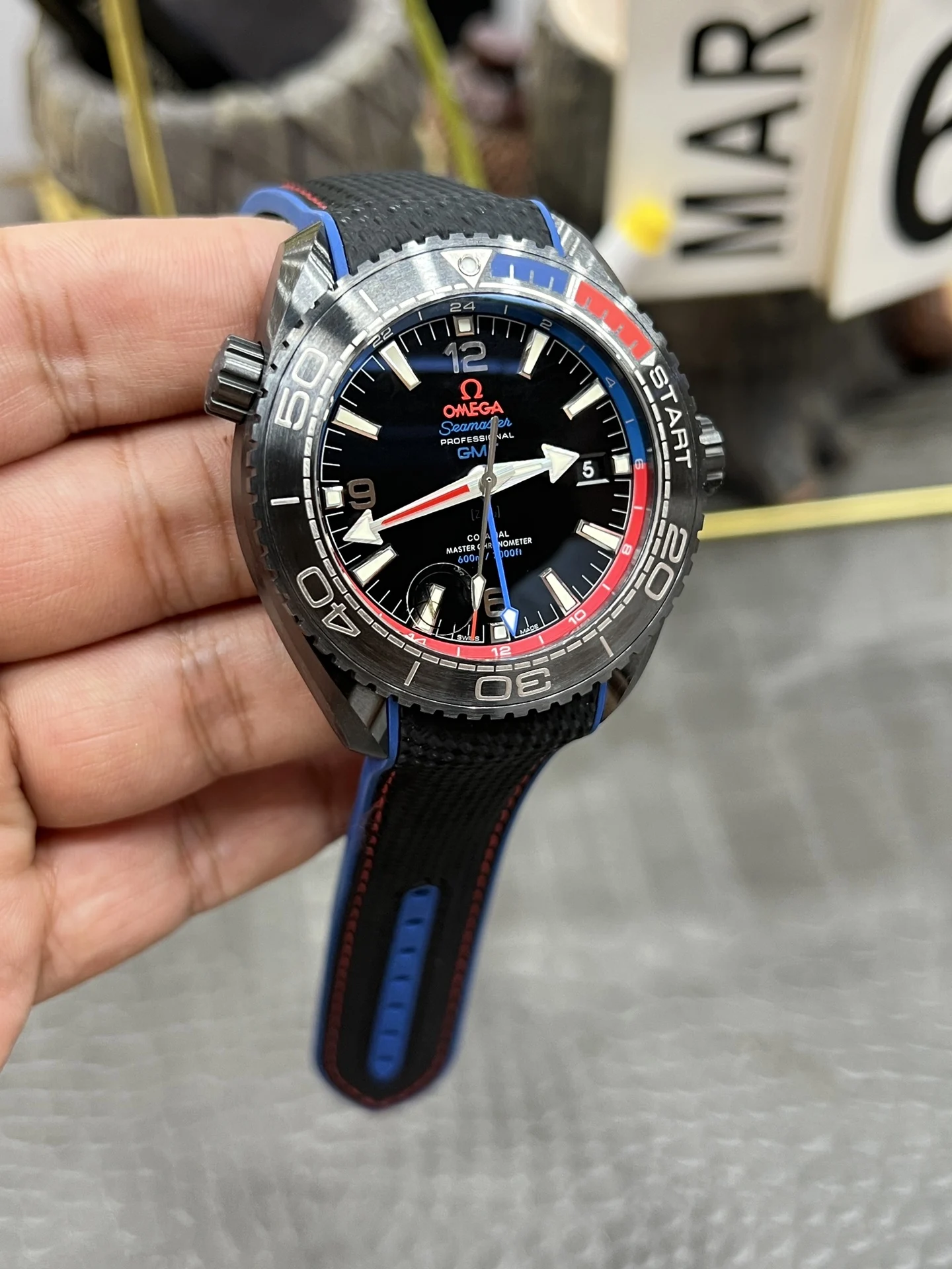 Omega Seamaster Planet Ocean Ceramic Red Dial — photographed off the sweep