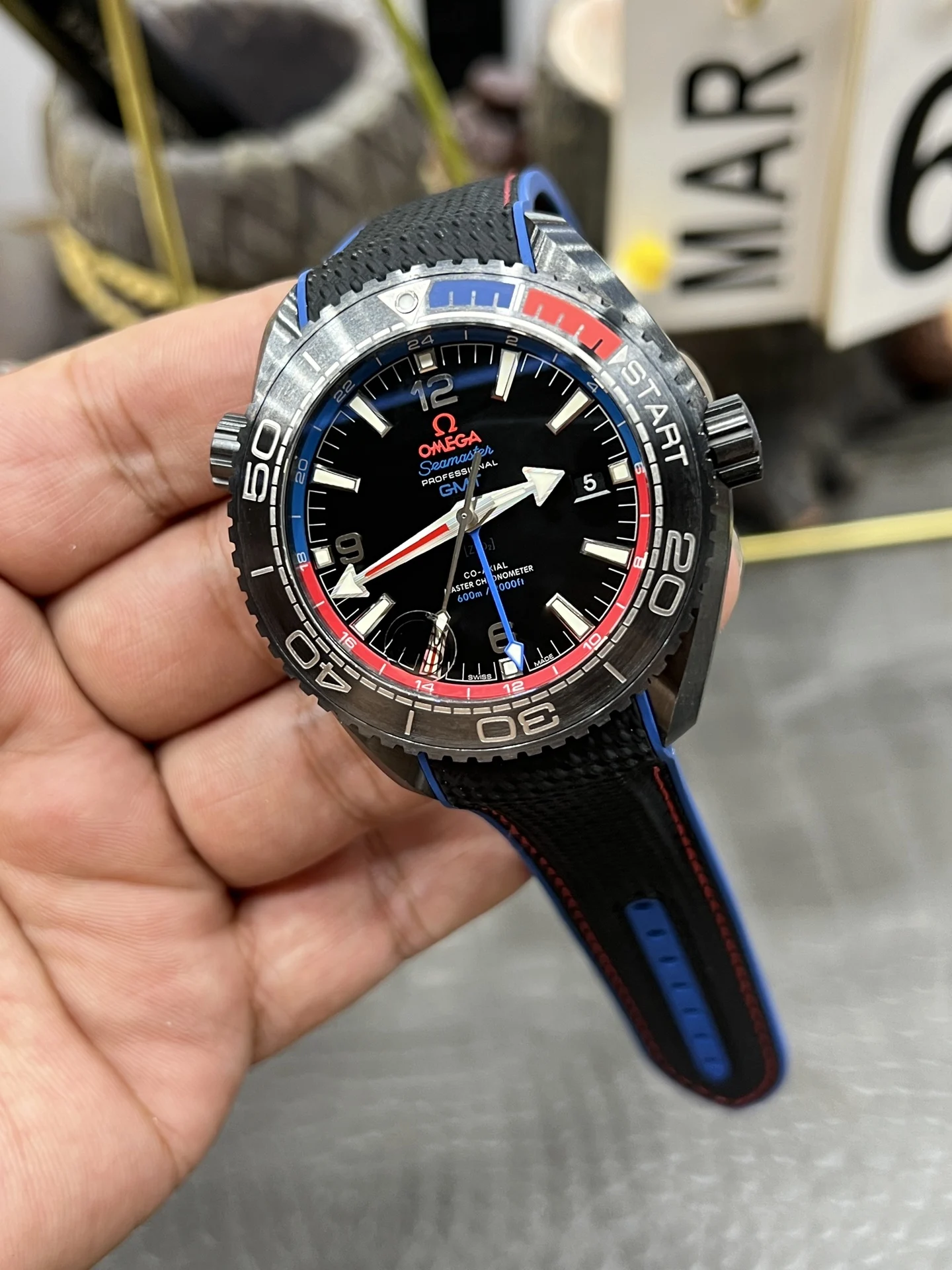 Omega Seamaster Planet Ocean Ceramic Red Dial — photographed off the sweep