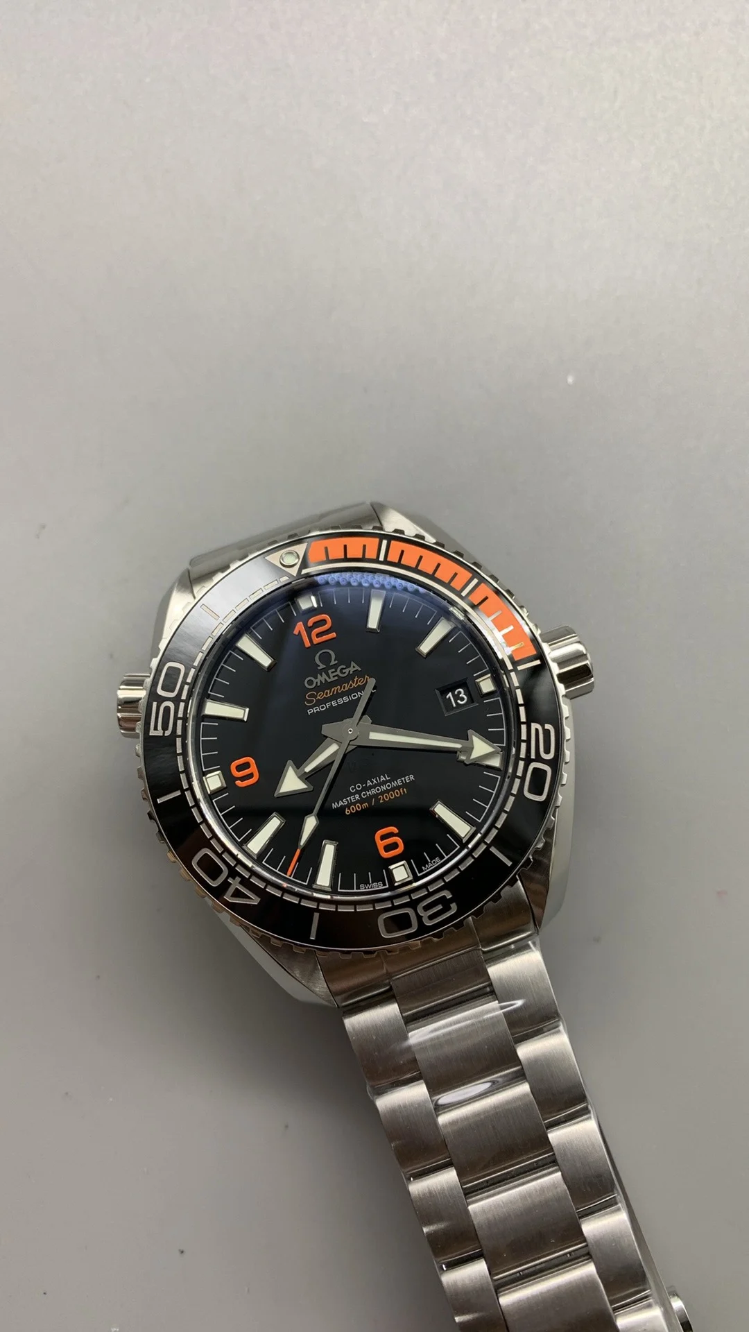 Omega Seamaster Planet Ocean Orange Dial — photographed off the sweep