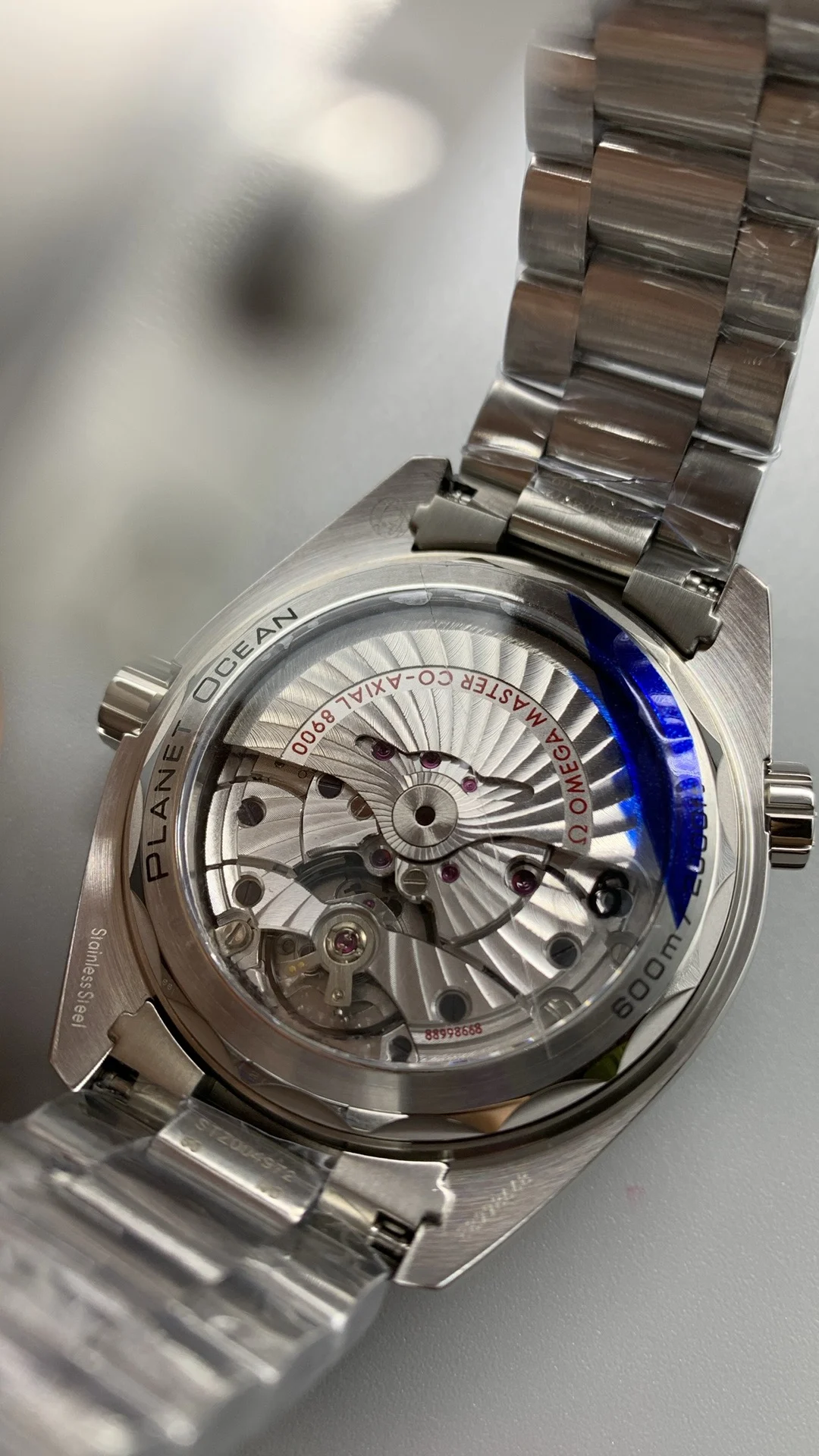 Omega Seamaster Planet Ocean Orange Dial — photographed off the sweep