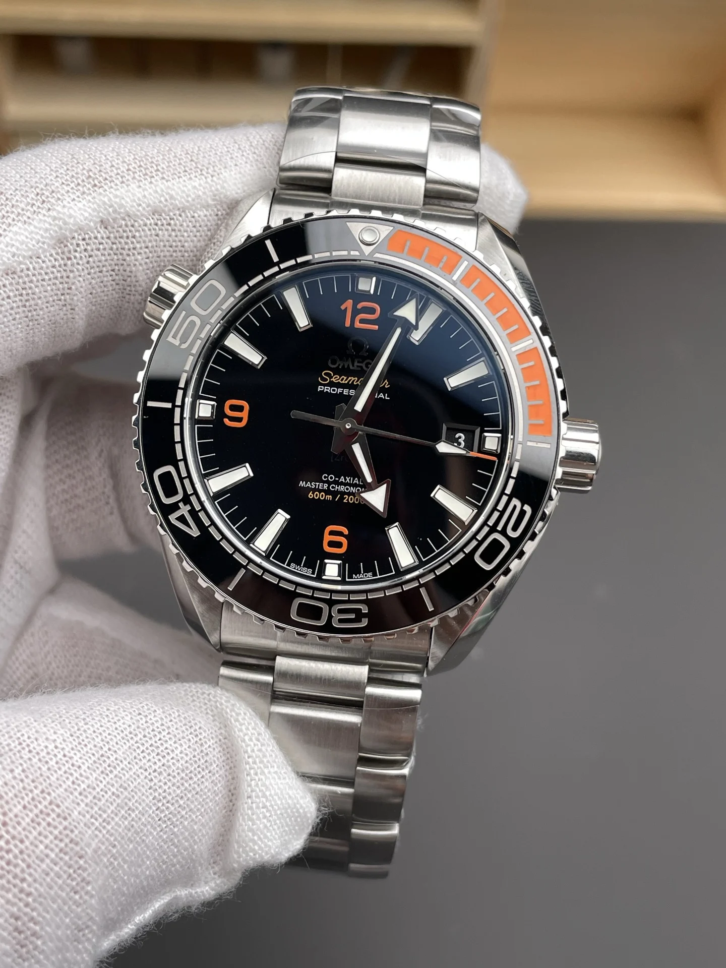 Omega Seamaster Planet Ocean Orange Dial 43.5mm — photographed off the sweep