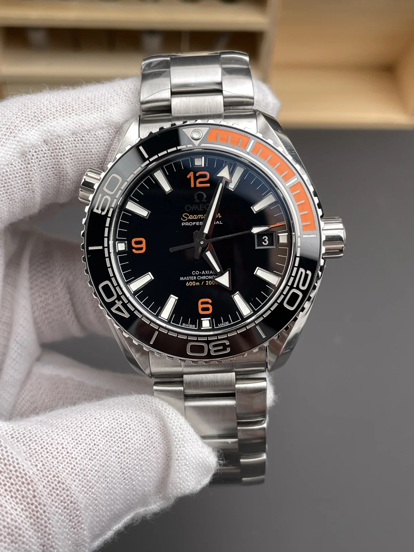 Omega Seamaster Planet Ocean Orange Dial 43.5mm — photographed off the sweep