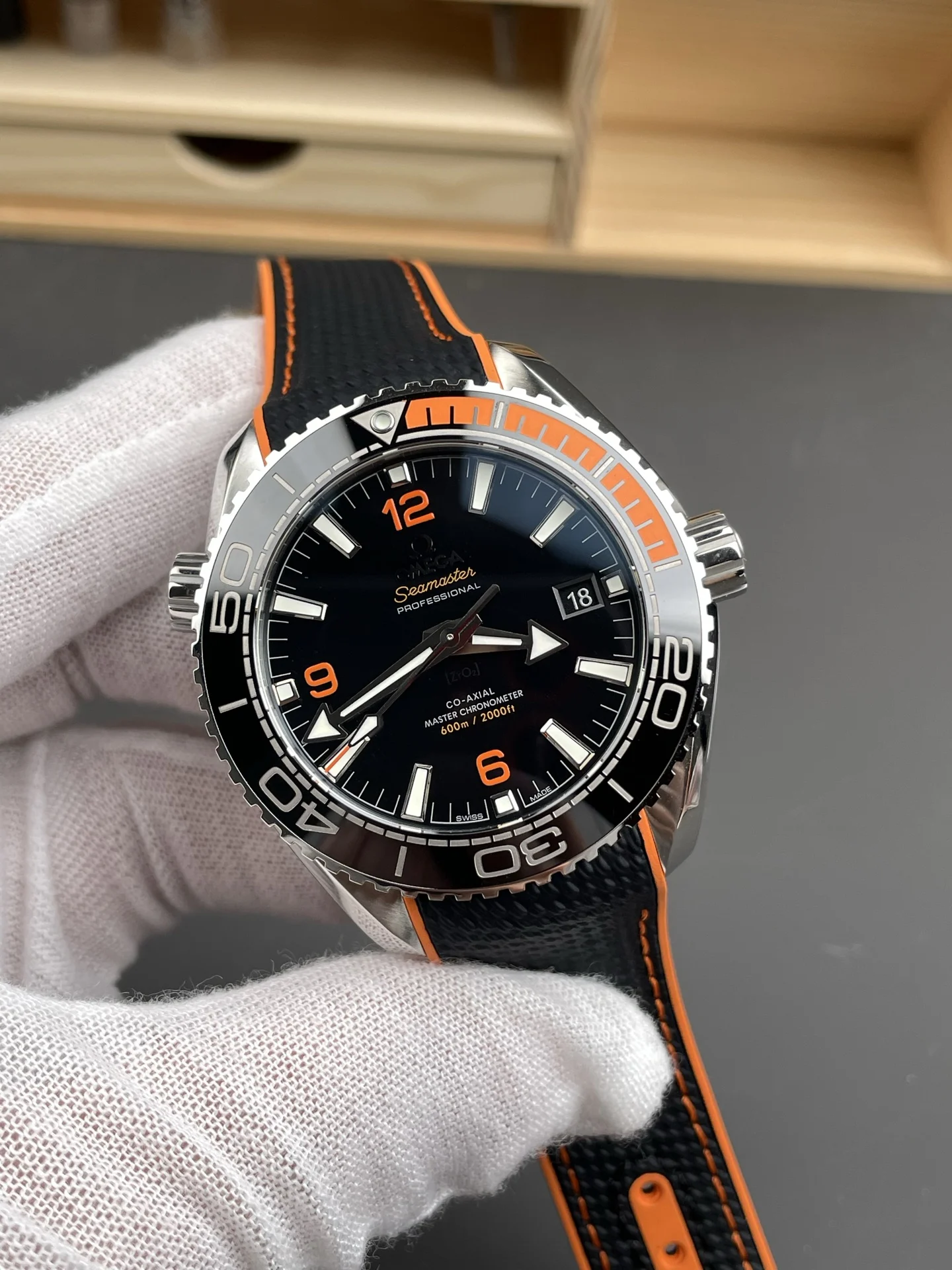 Omega Seamaster Planet Ocean Orange Dial 43.5mm — photographed off the sweep