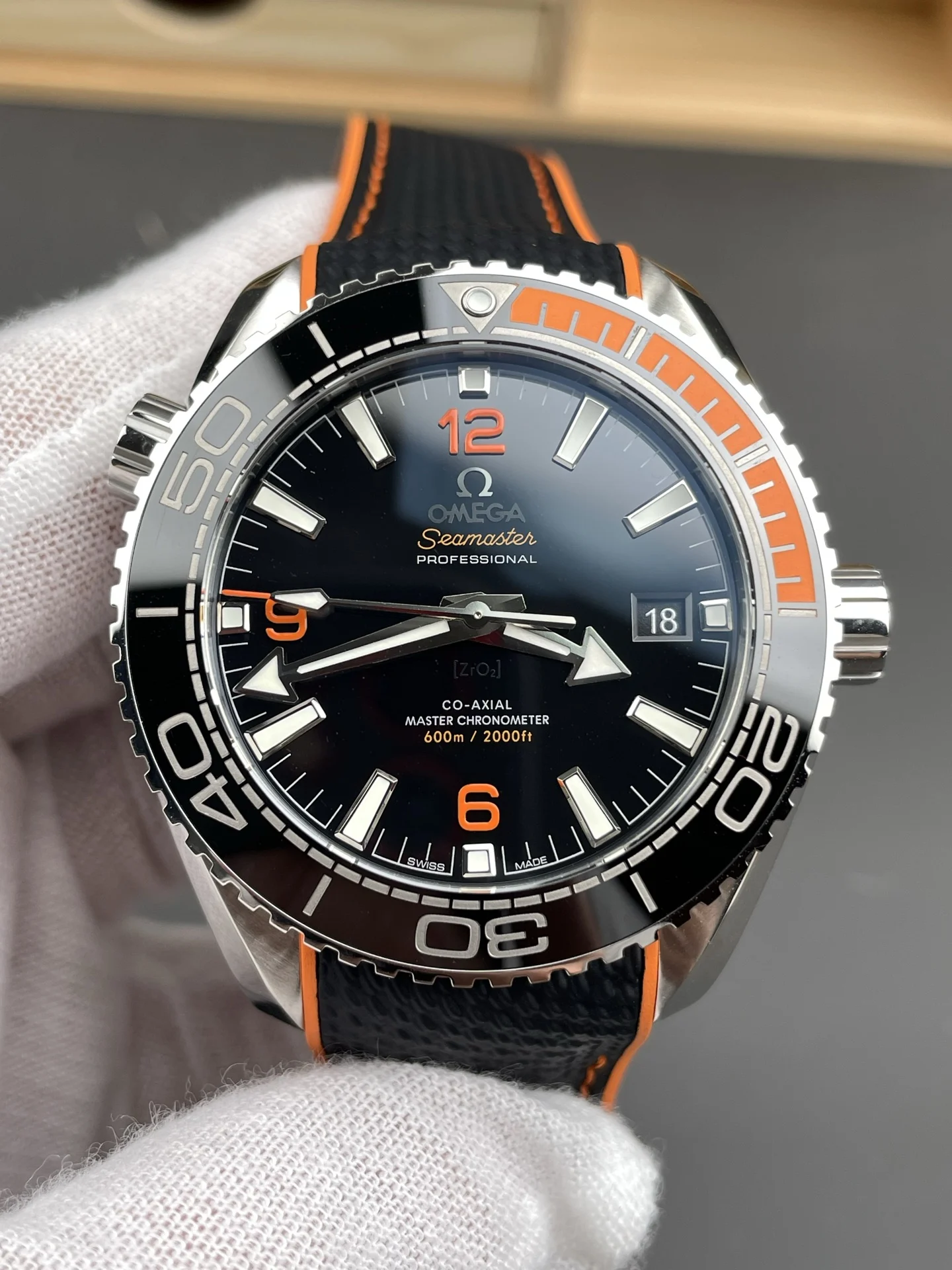 Omega Seamaster Planet Ocean Orange Dial 43.5mm — photographed off the sweep