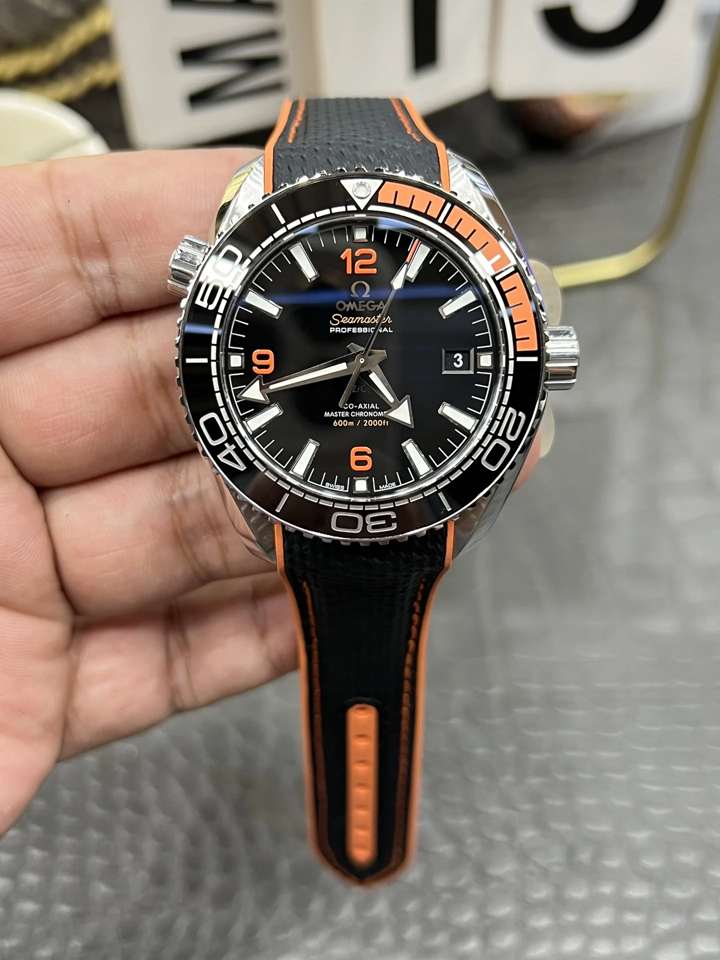 Omega Seamaster Planet Ocean Orange Dial 43.5mm — photographed off the sweep