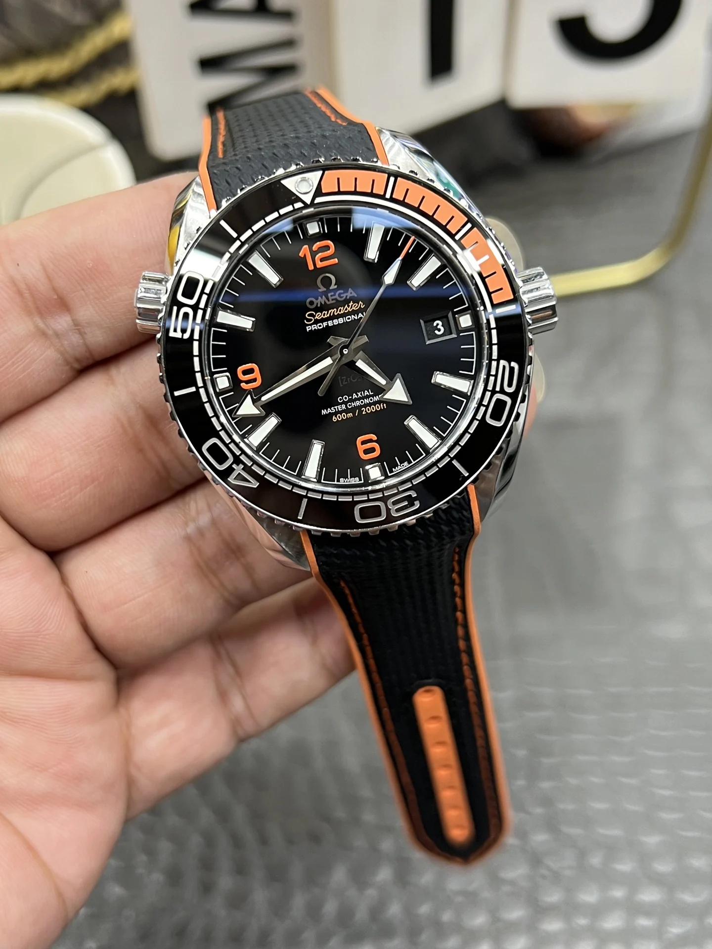 Omega Seamaster Planet Ocean Orange Dial 43.5mm — photographed off the sweep