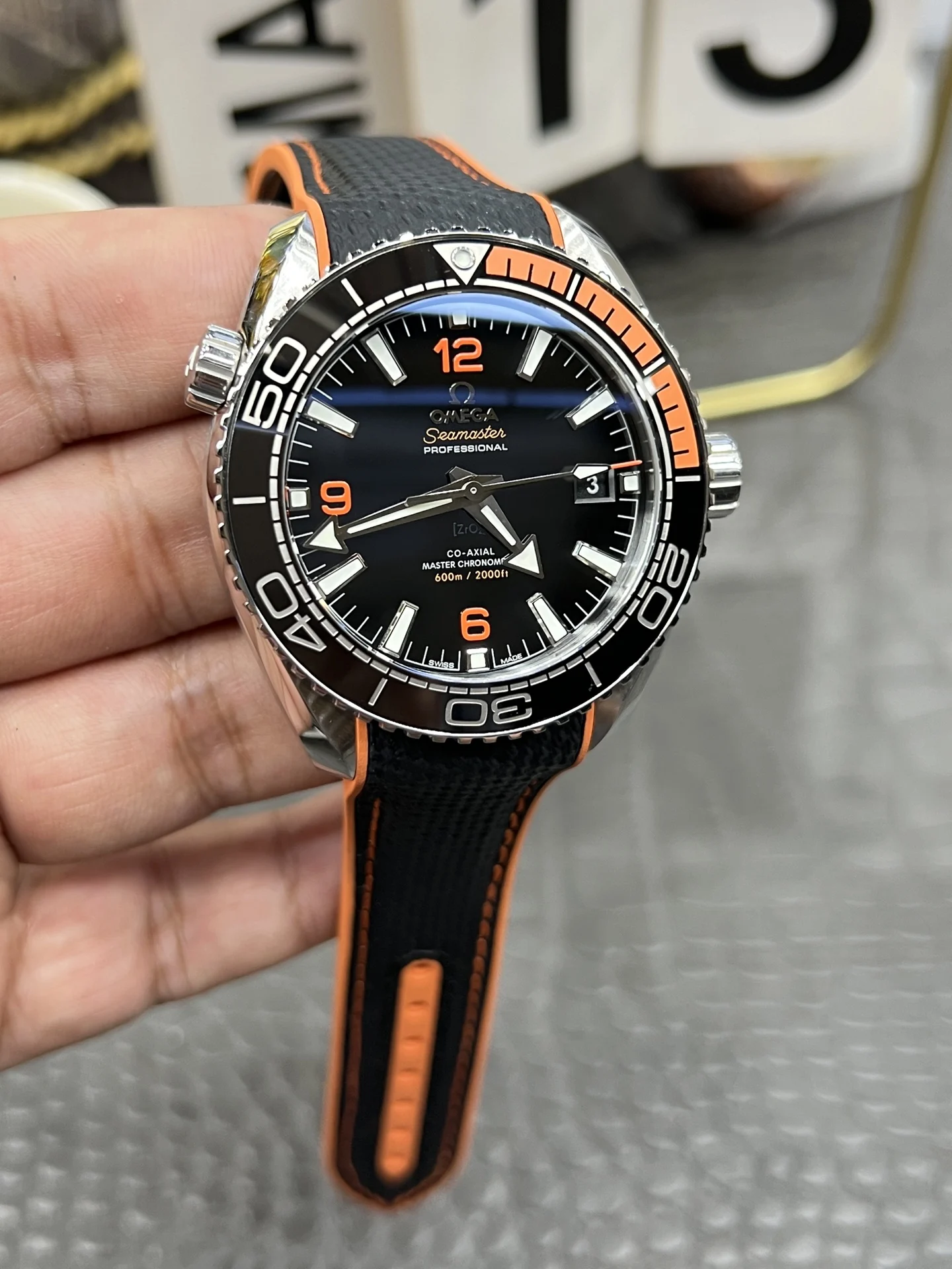 Omega Seamaster Planet Ocean Orange Dial 43.5mm — photographed off the sweep