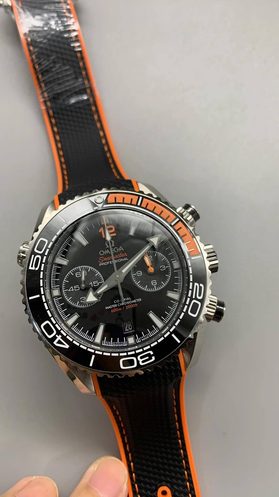 Omega Seamaster Planet Ocean Orange Dial — photographed off the sweep