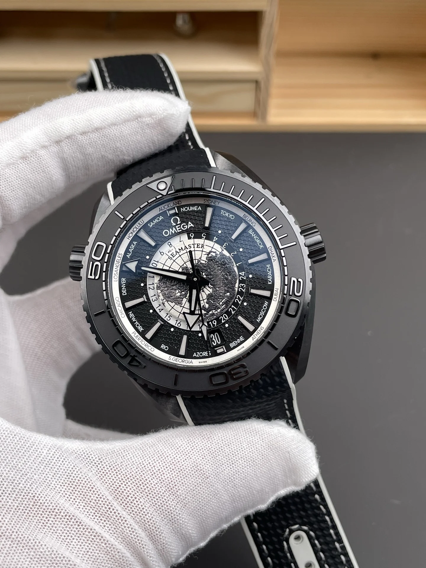 Omega Seamaster Planet Ocean World Time 45.5mm — photographed off the sweep