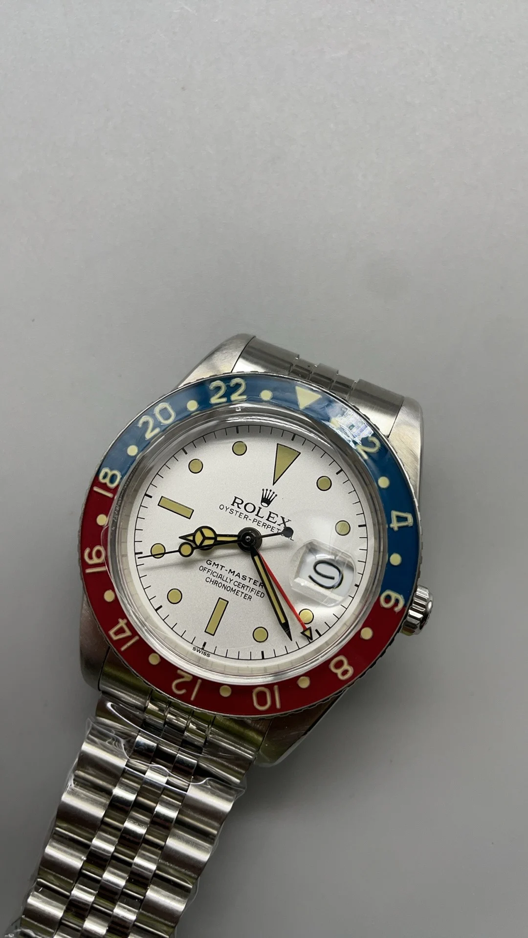 Retro, GMT, Coke white plate — photographed off the sweep