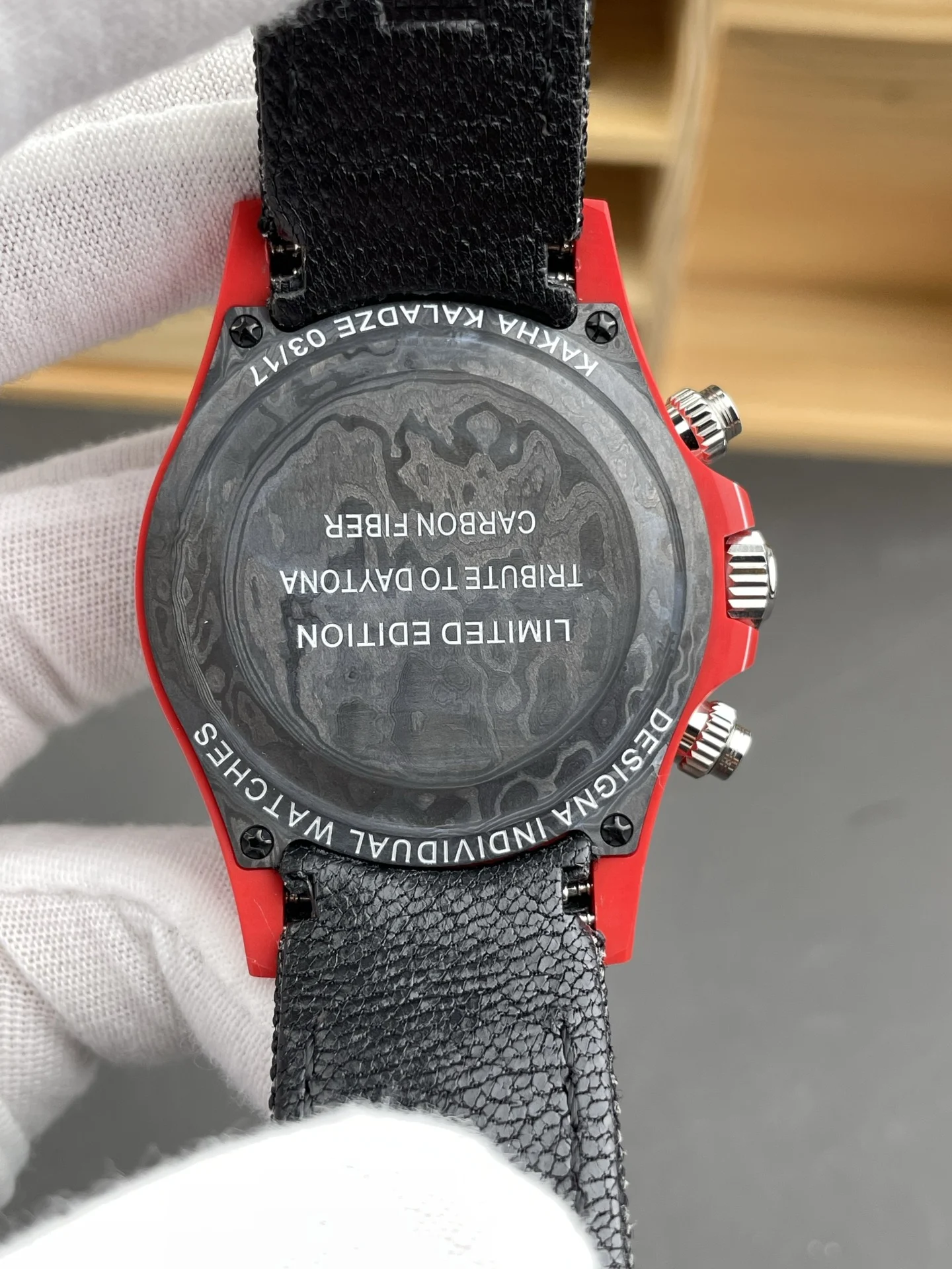 Rolex Daytona Carbon Red Dial — photographed off the sweep