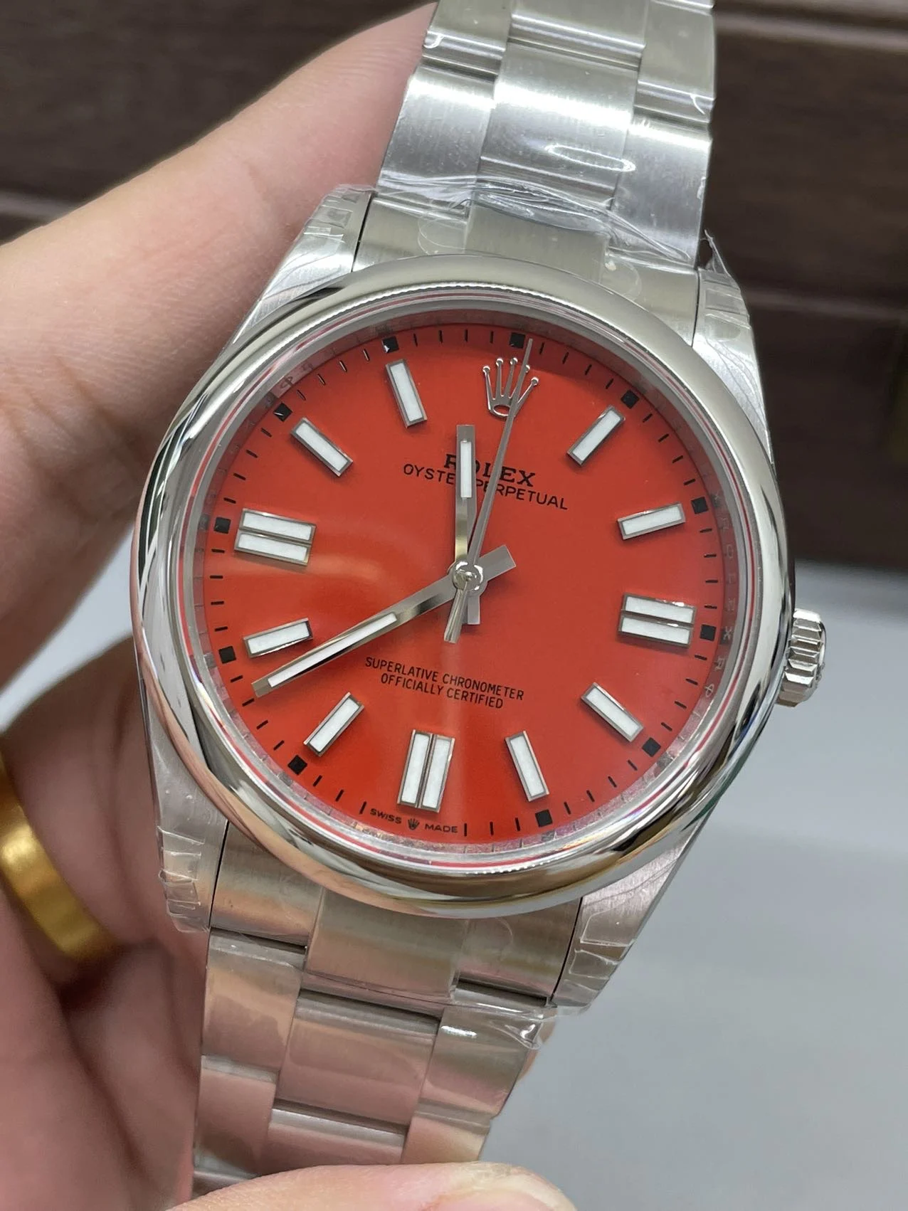 Rolex Oyster Perpetual Red Dial 41mm — photographed off the sweep
