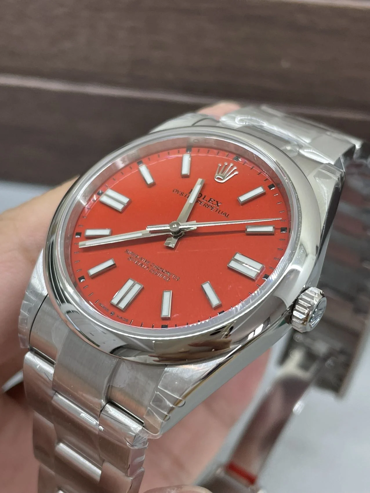 Rolex Oyster Perpetual Red Dial 41mm — photographed off the sweep