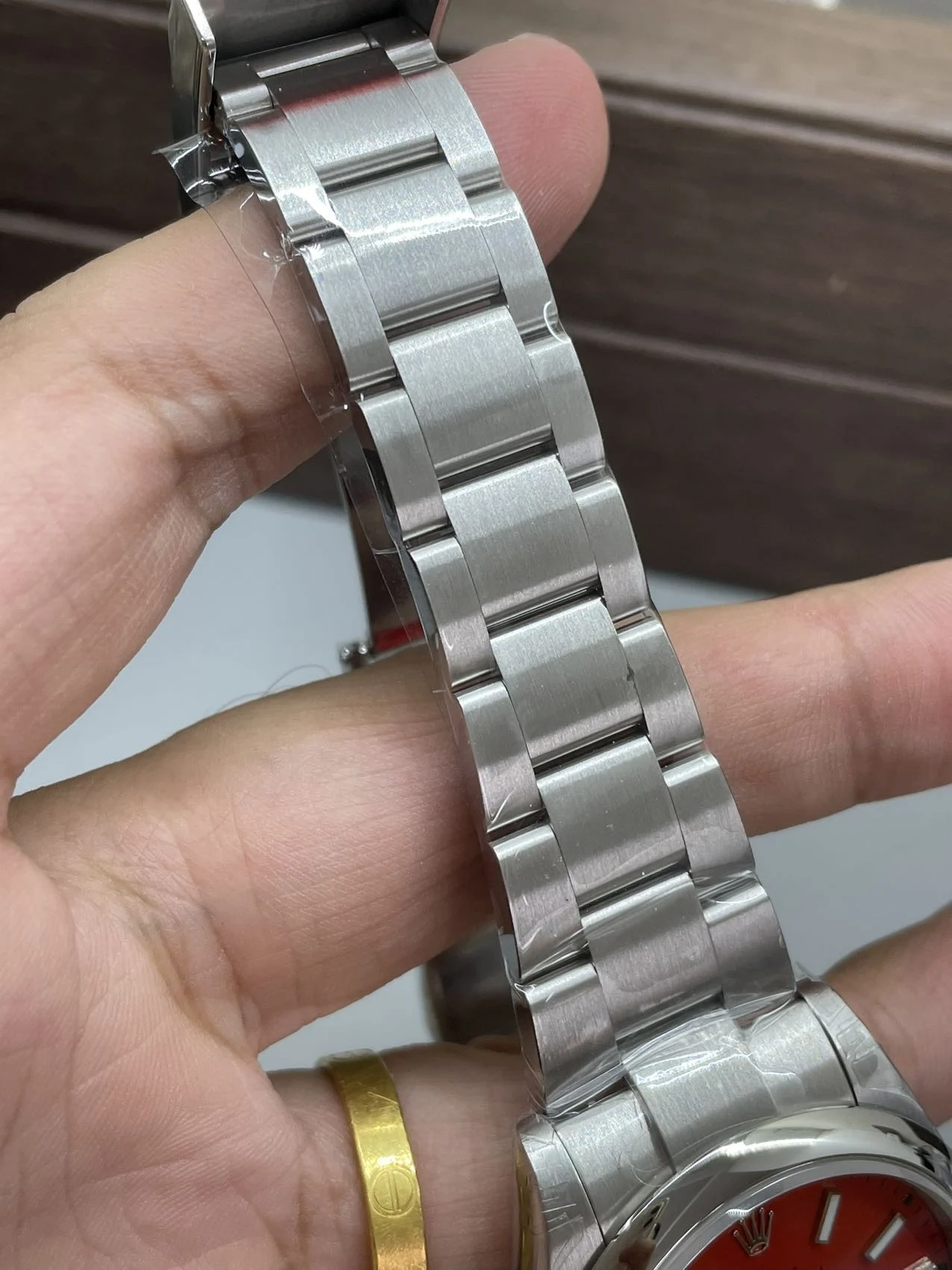 Rolex Oyster Perpetual Red Dial 41mm — photographed off the sweep