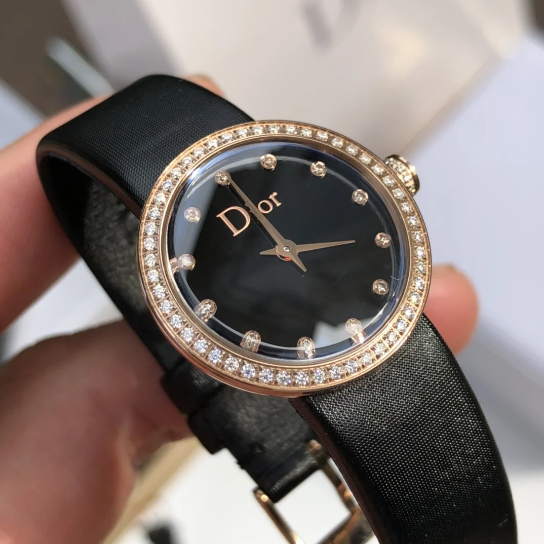Stainless steel case, 25mm diameter gold bezel and crown set — photographed off the sweep