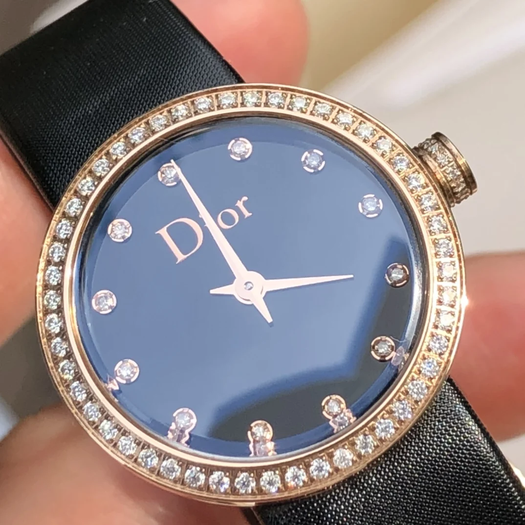 Stainless steel case, 25mm diameter gold bezel and crown set — photographed off the sweep