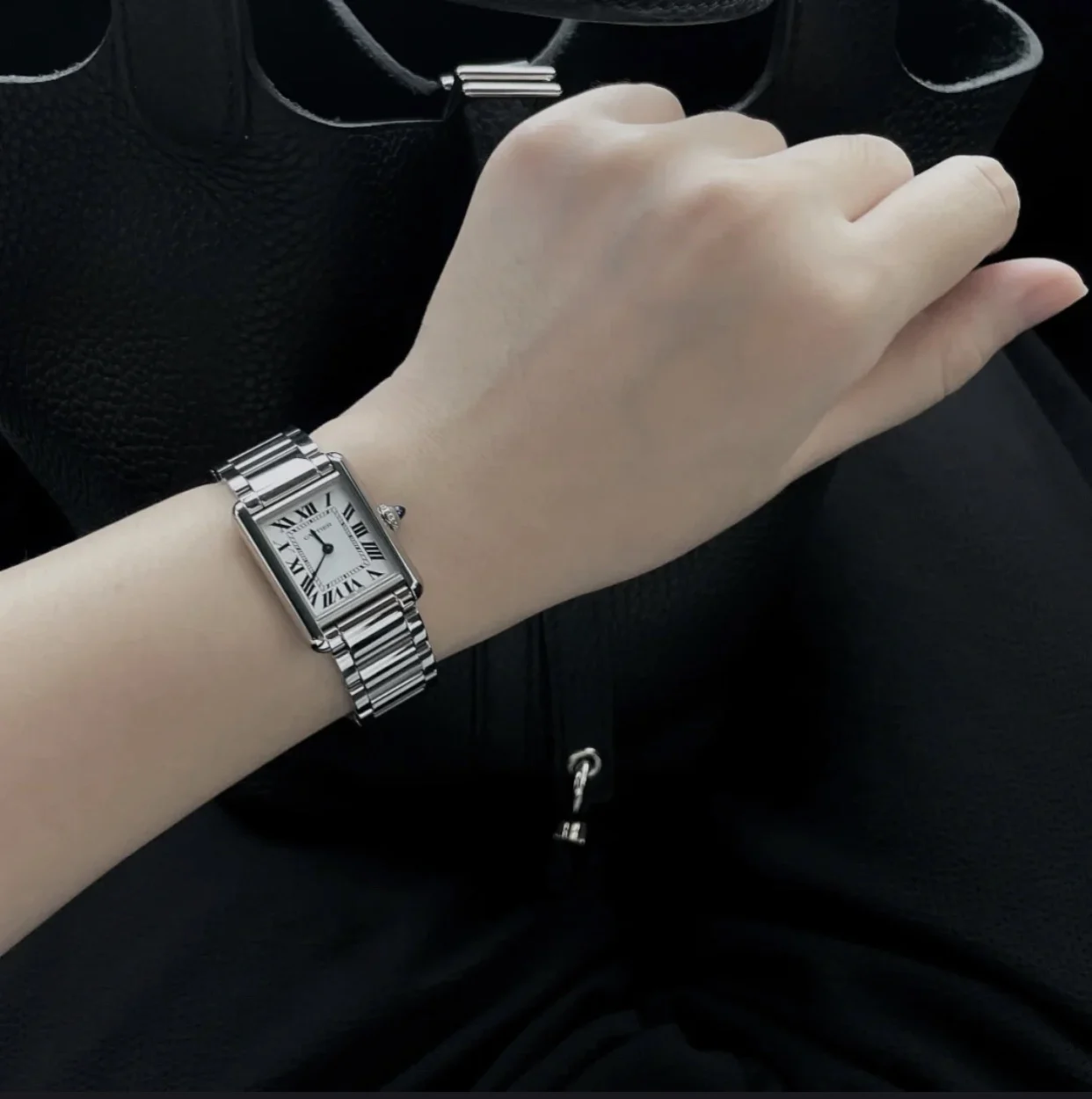 Steel bracelet on the wrist — photographed off the sweep
