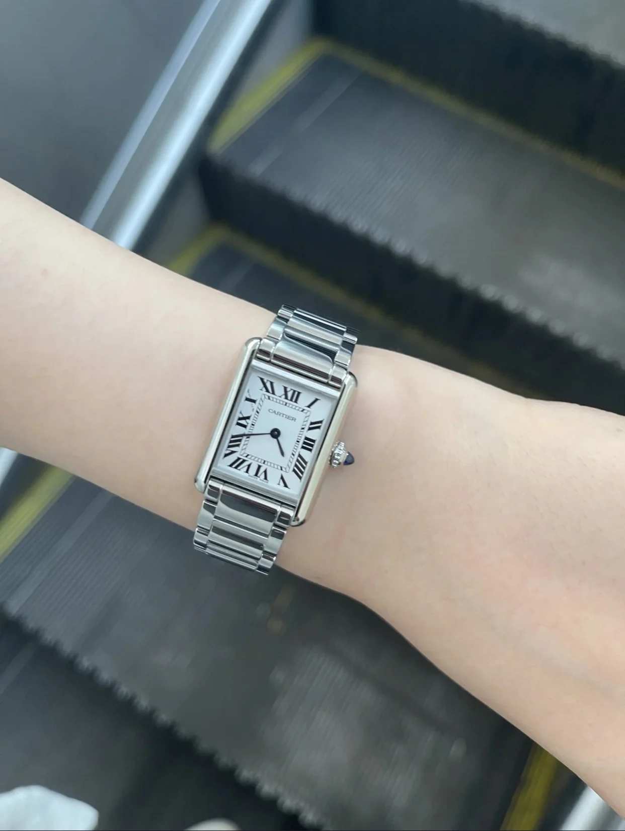 Steel bracelet on the wrist — photographed off the sweep