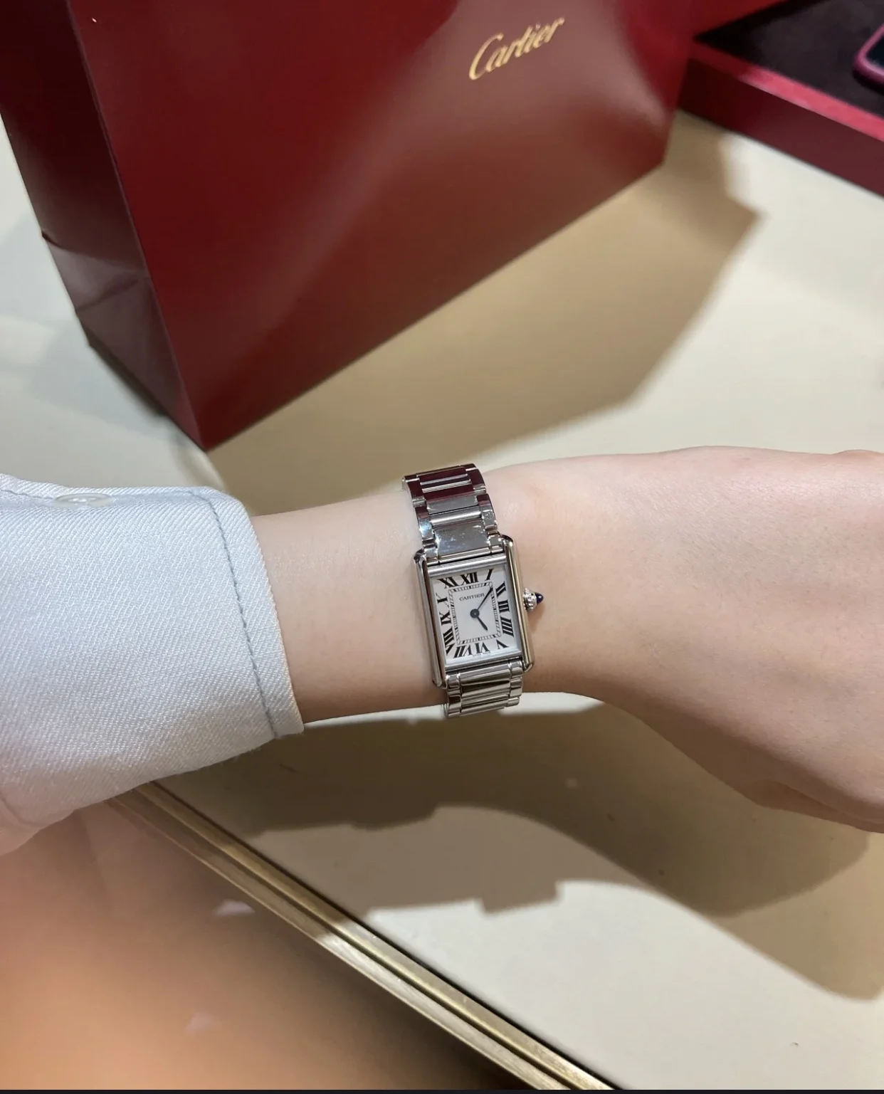 Steel bracelet on the wrist — photographed off the sweep