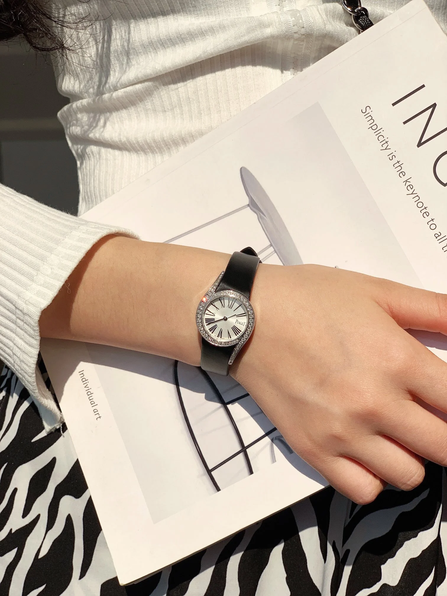 The elegant black Roman numeral hour markers, as seen in