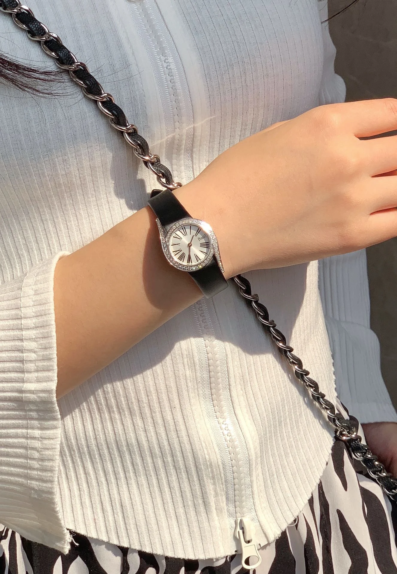 The elegant black Roman numeral hour markers, as seen in — photographed off the sweep