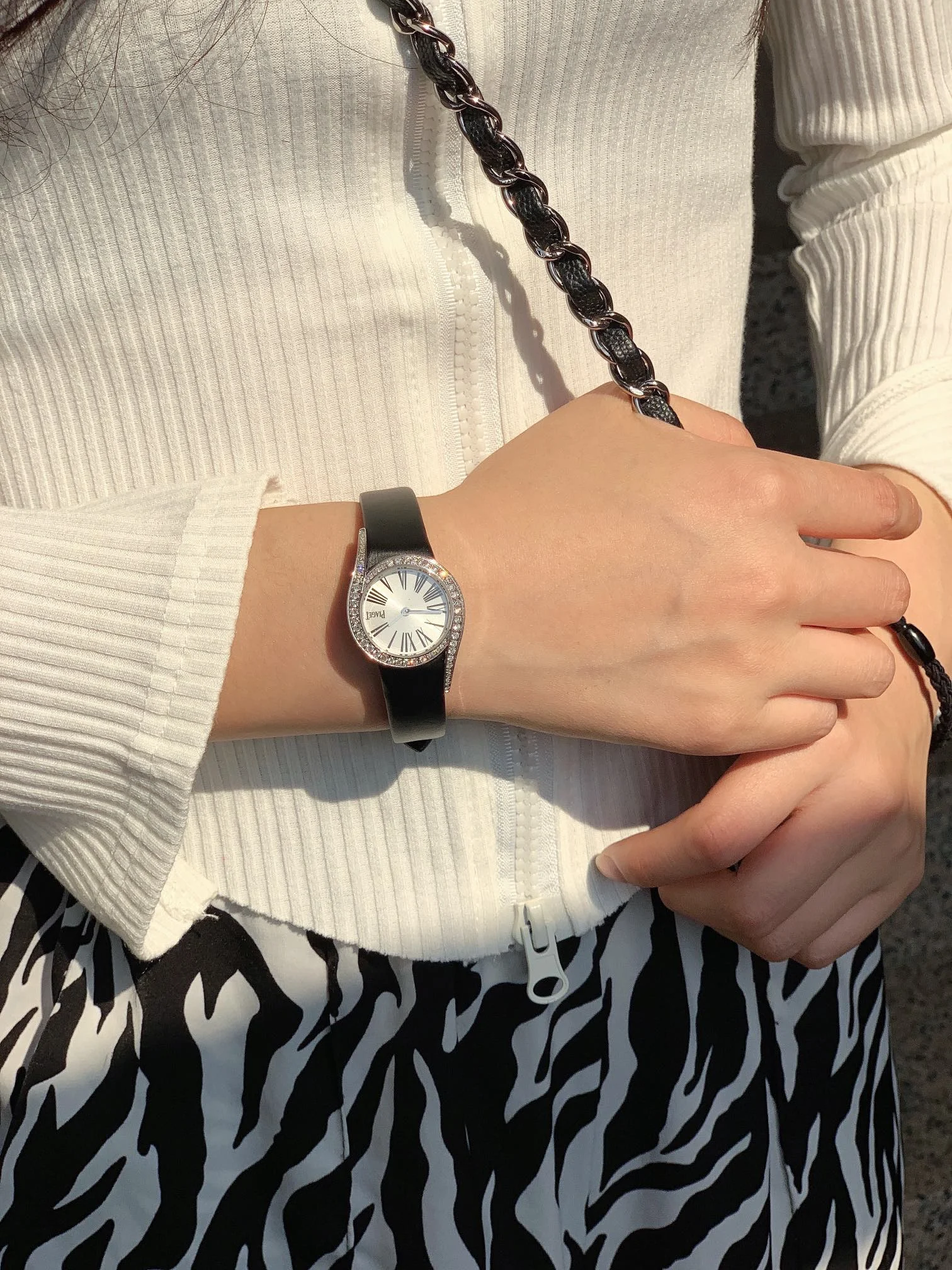 The elegant black Roman numeral hour markers, as seen in — photographed off the sweep