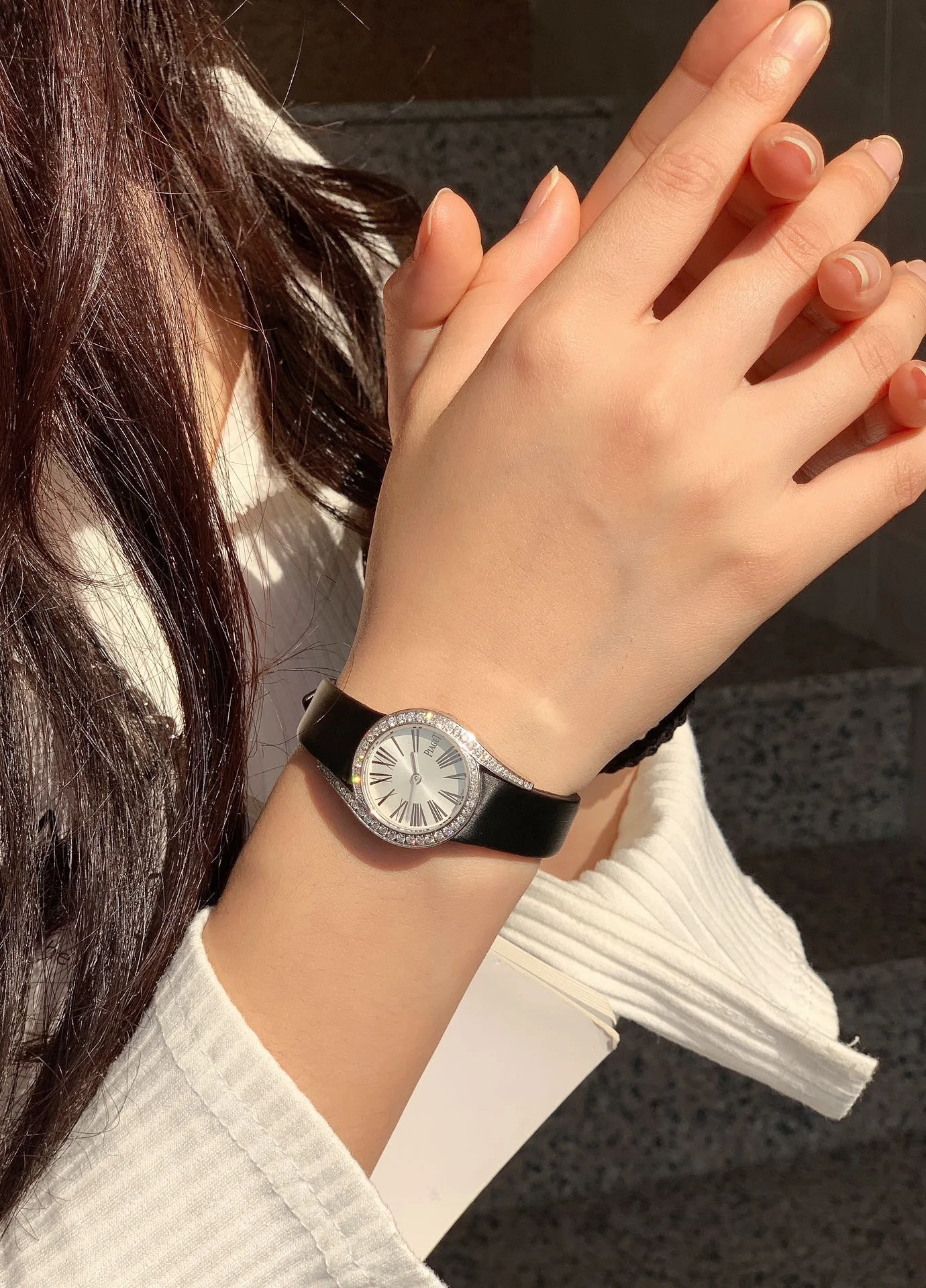 The elegant black Roman numeral hour markers, as seen in — photographed off the sweep