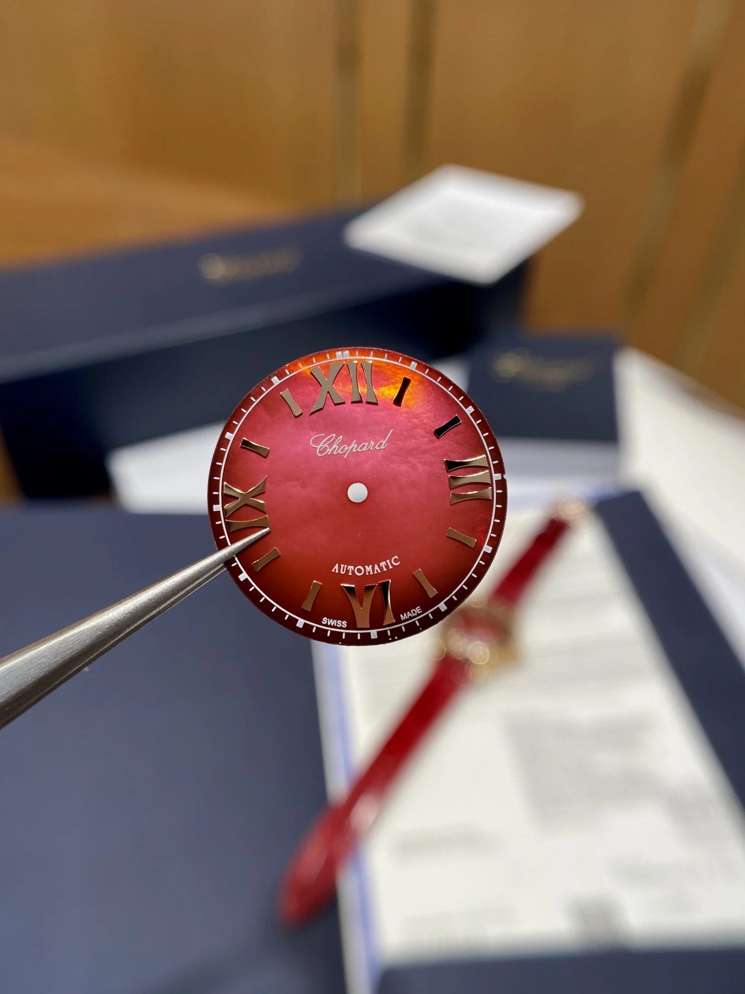 The pomegranate red dial is absolutely gorgeous; it displays — photographed off the sweep