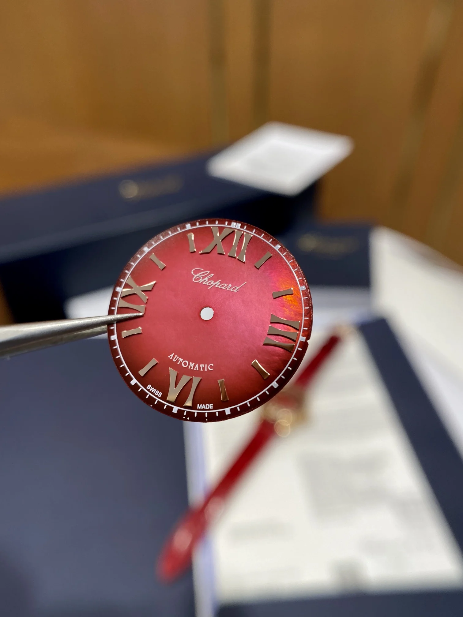 The pomegranate red dial is absolutely gorgeous; it displays — photographed off the sweep