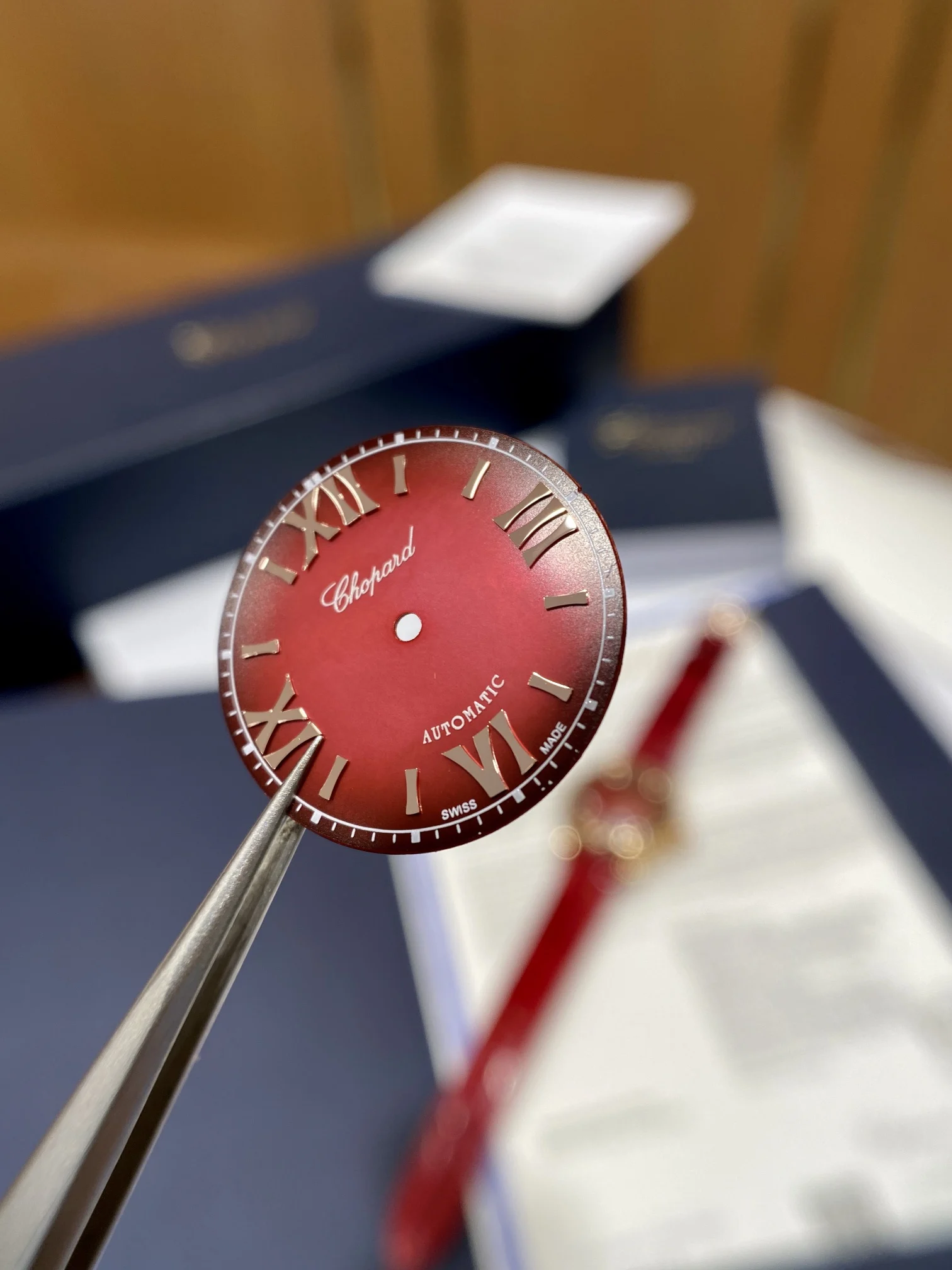The pomegranate red dial is absolutely gorgeous; it displays — photographed off the sweep