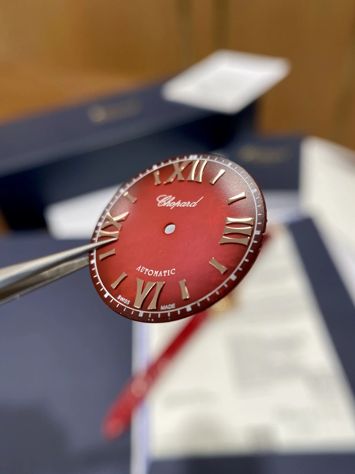The pomegranate red dial is absolutely gorgeous; it displays — photographed off the sweep